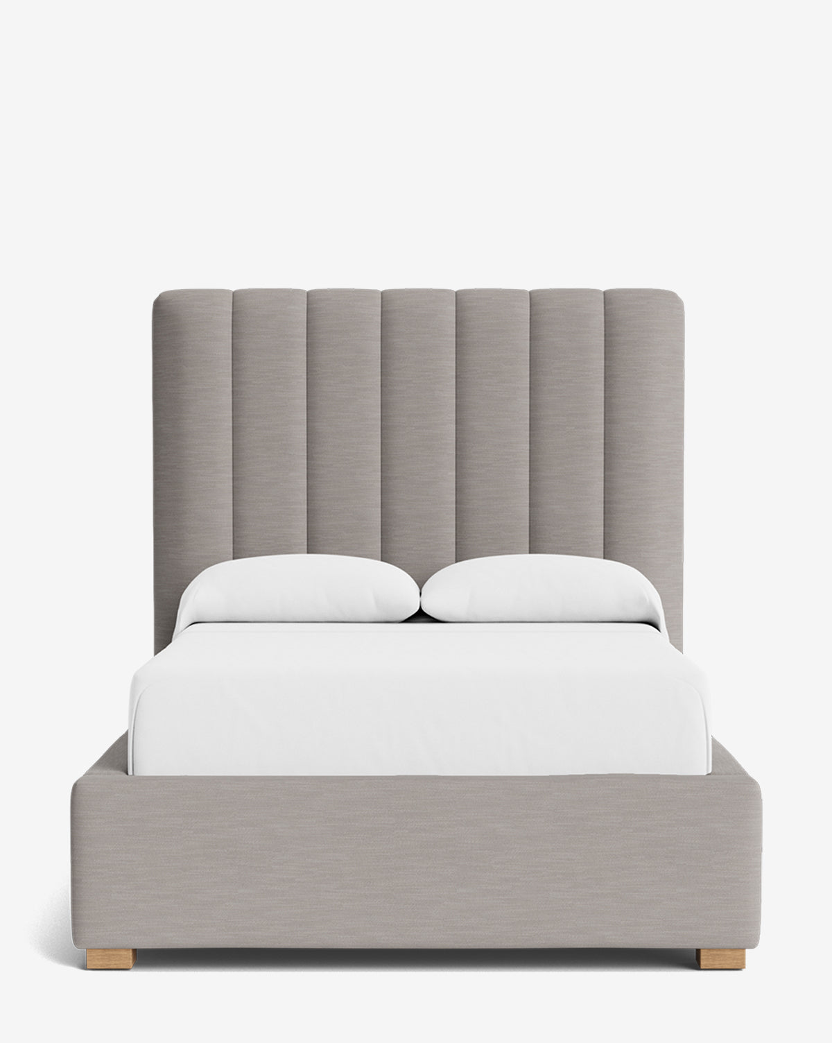 The Hoffman Bed Tall Headboard features a tall, vertically paneled upholstered headboard in customizable fabrics with light gray fabric, white bedding, and wooden legs, displayed against a plain white background by McGee & Co.