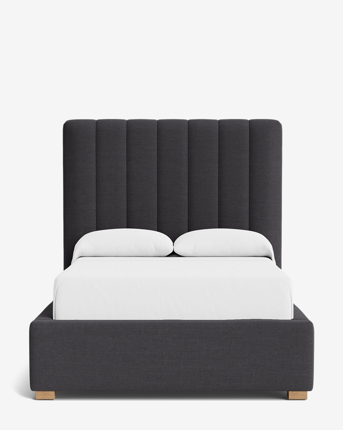 The Hoffman Bed Tall Headboard features a tall, vertically paneled dark gray headboard, matching frame, light wooden legs, white bedding with two pillows, and is available in customizable fabrics to match your style, by McGee & Co.