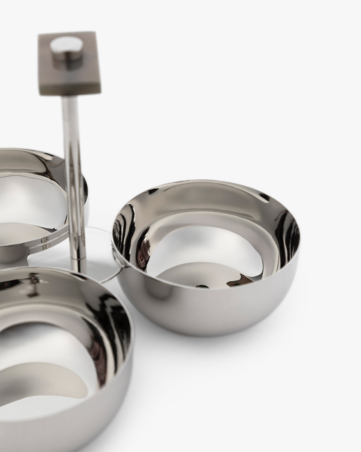 The Holland Condiment Set features shiny stainless steel bowls with a nickel polish on a sleek metal stand and a square horn-crafted handle, all photographed against a white background—ideal for adding modern style to your table, by Vendixs