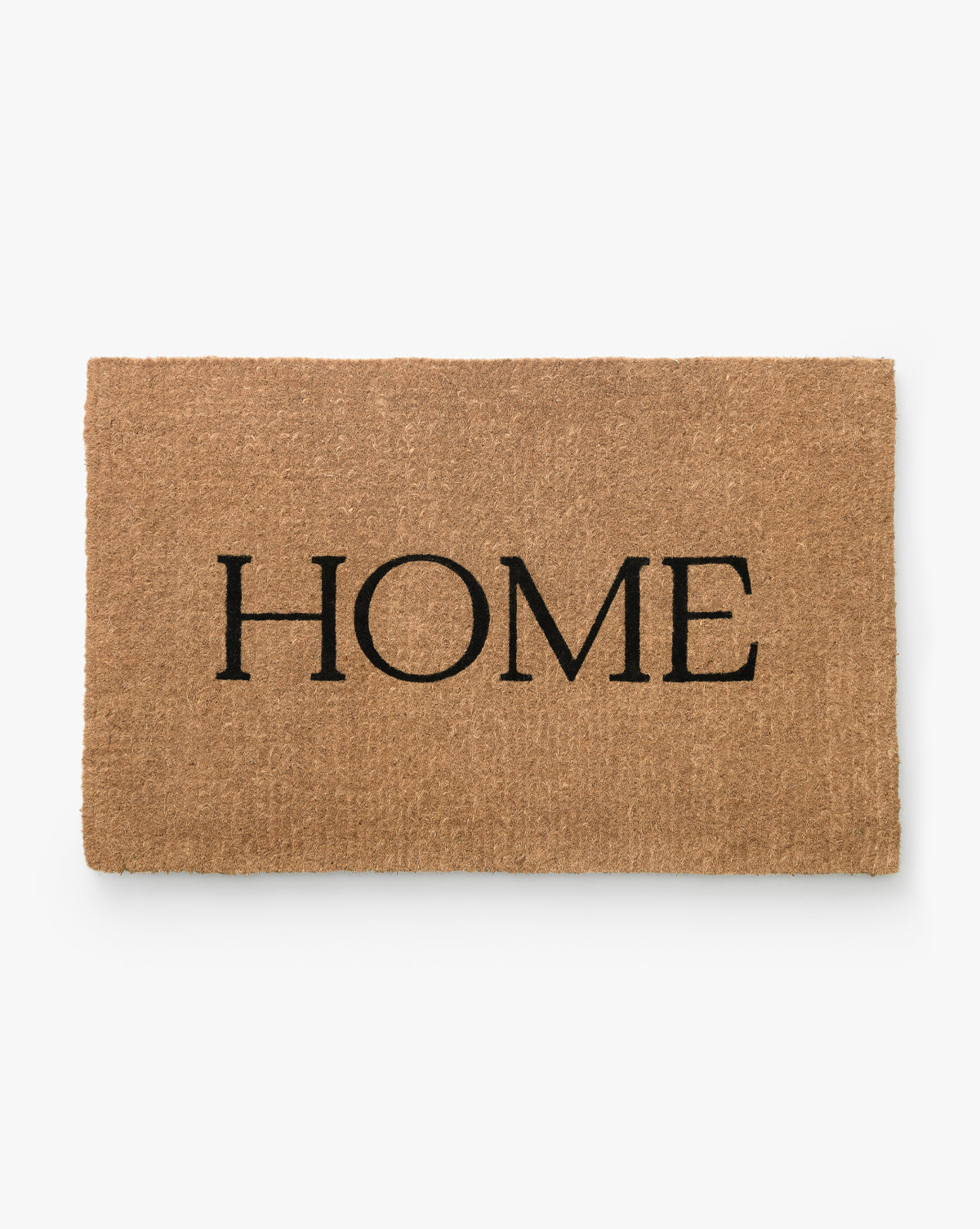 The Palm Fiber Home Doormat is a rectangular, handwoven coir mat in brown with HOME in bold black letters at the center, shown on a white background. Vendixs