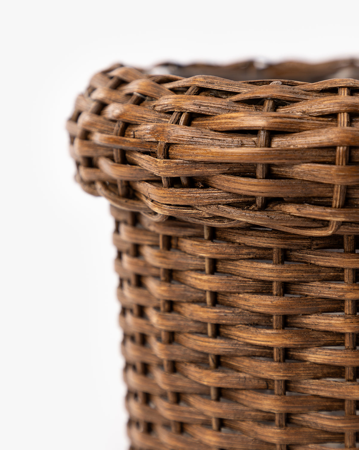 Close-up of the Huger Woven Planter's upper portion, showcasing its detailed texture and interlaced brown fibers against a white background, by McGee & Co.