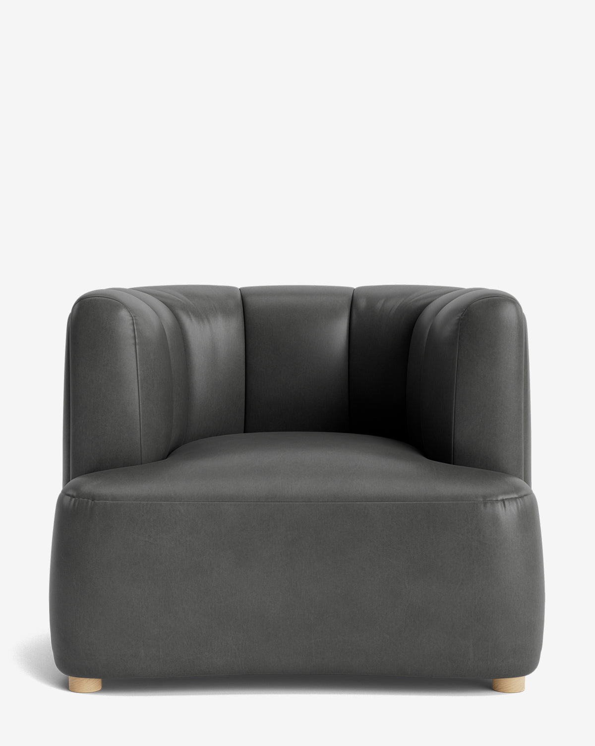 The Ines Lounge Chair is a modern, dark gray velvet chair with a low profile, wide seat, rounded edges, subtle vertical tufting on the backrest, and small light wooden feet. It’s displayed against a plain white background by McGee & Co.