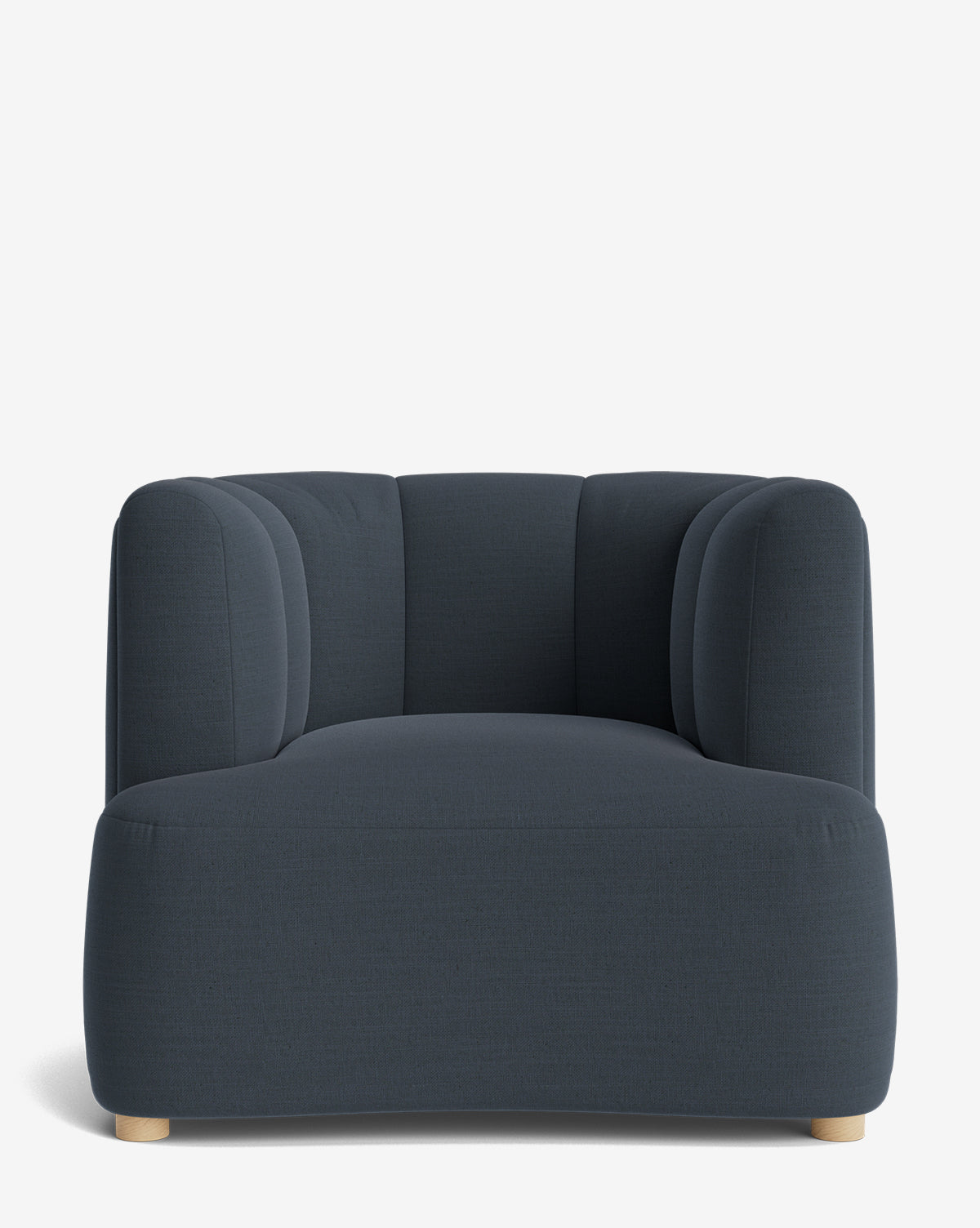 The Ines Lounge Chair is a modern, dark gray velvet armchair featuring rounded, cushioned sides and backrest, short light wood legs, soft curves, a low profile, and minimalist design that adds contemporary style to any space by McGee & Co.