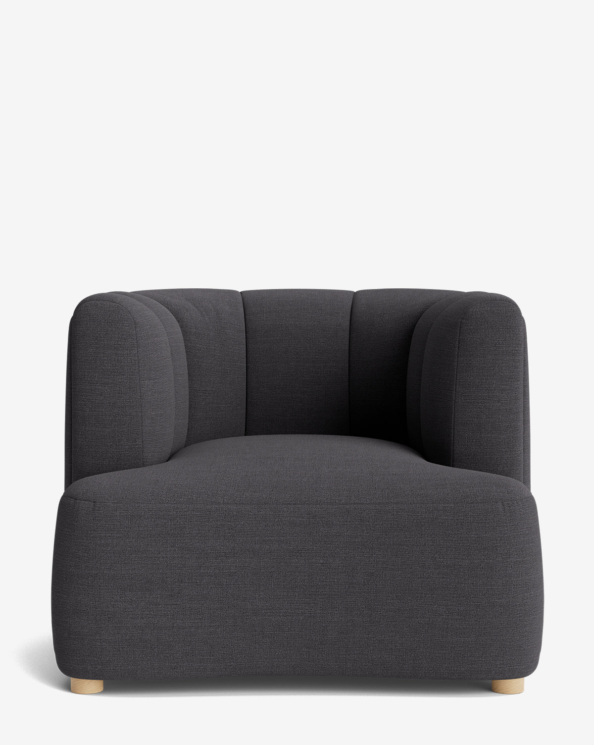 The Ines Lounge Chair is a dark gray, modern velvet chair with rounded edges, a deep seat, plush upholstery, low wooden feet, and a curved tufted backrest—shown against a plain white background by McGee & Co.