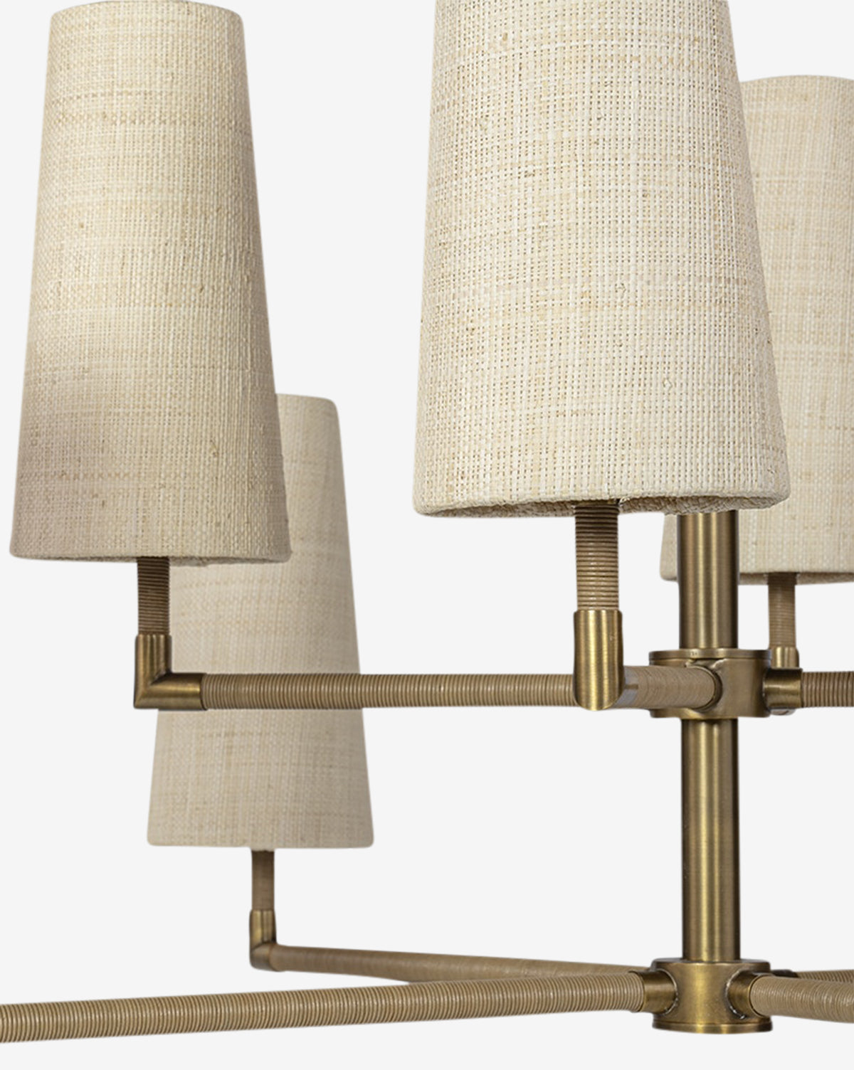 Close-up of the Irving Chandelier, showing its brass frame, leather-wrapped poles, and four textured natural raffia shades set against a white background, by Vendixs