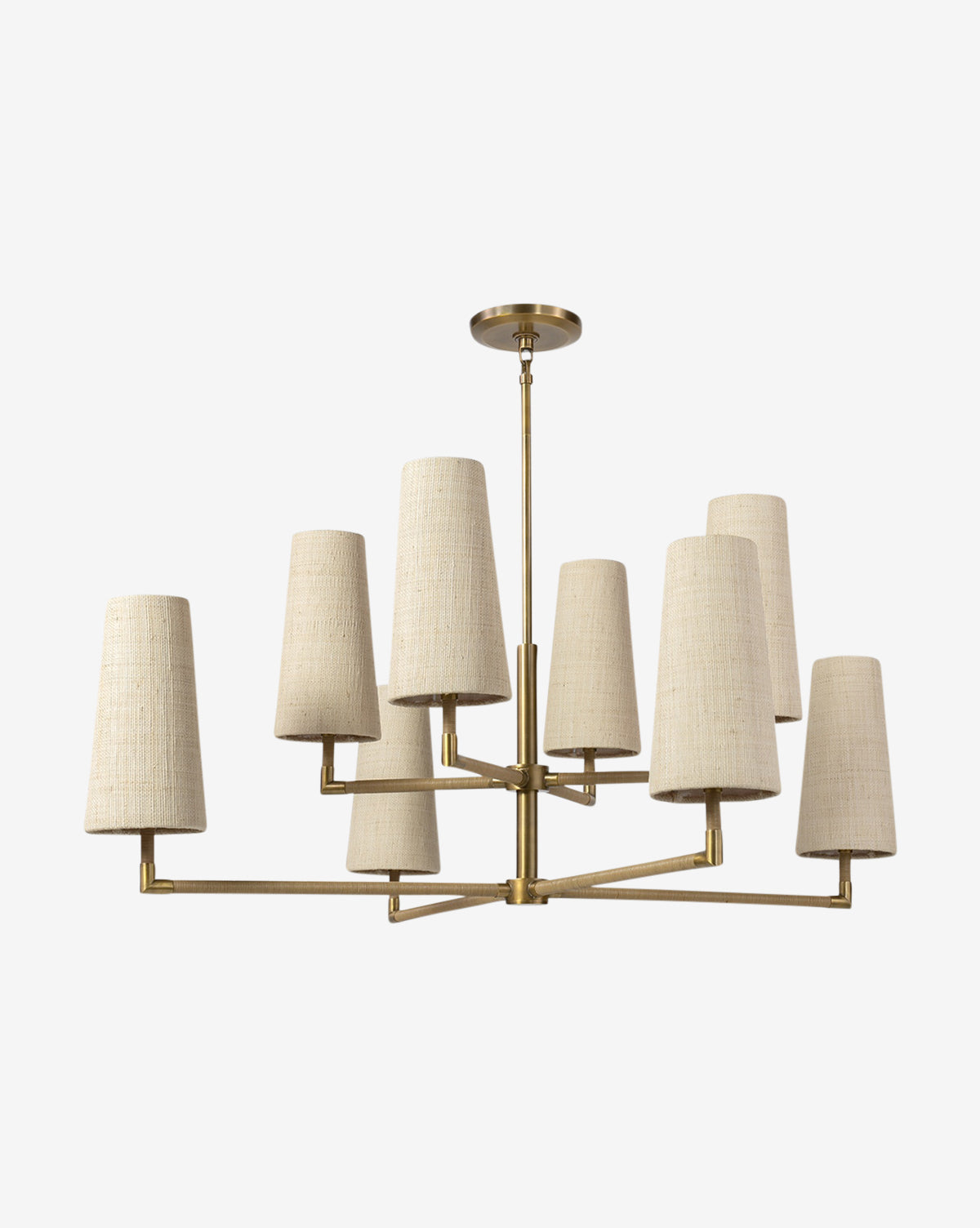 The Irving Chandelier by Palecek features a brass frame, leather-wrapped poles, and eight beige fabric drum shades in two tiers, all descending from a matching brass ceiling mount for a modern look. Vendixs
