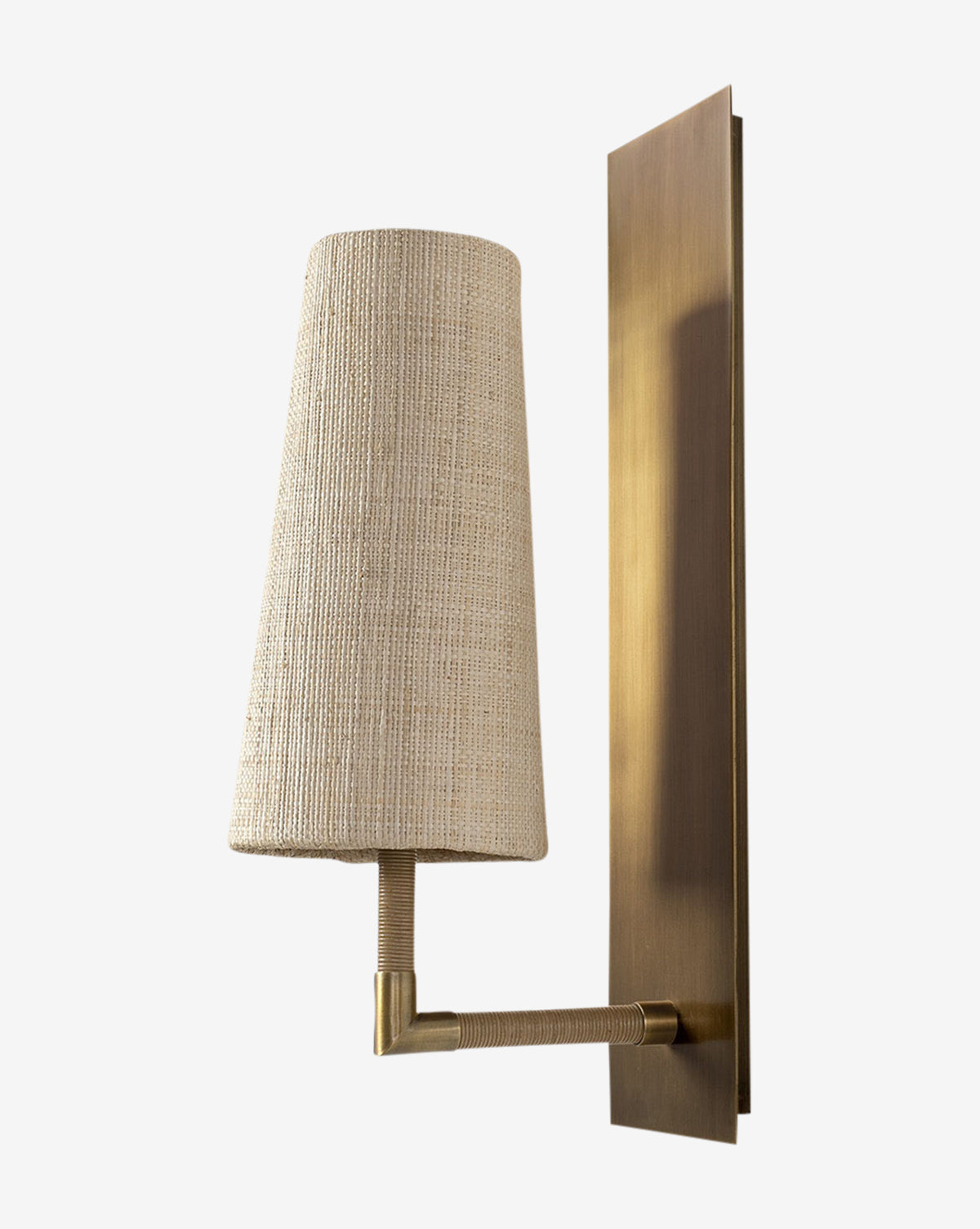 The Irving Sconce pairs a rectangular brass backplate and refined arm with a textured raffia shade, creating a warm, sophisticated accent, by Vendixs