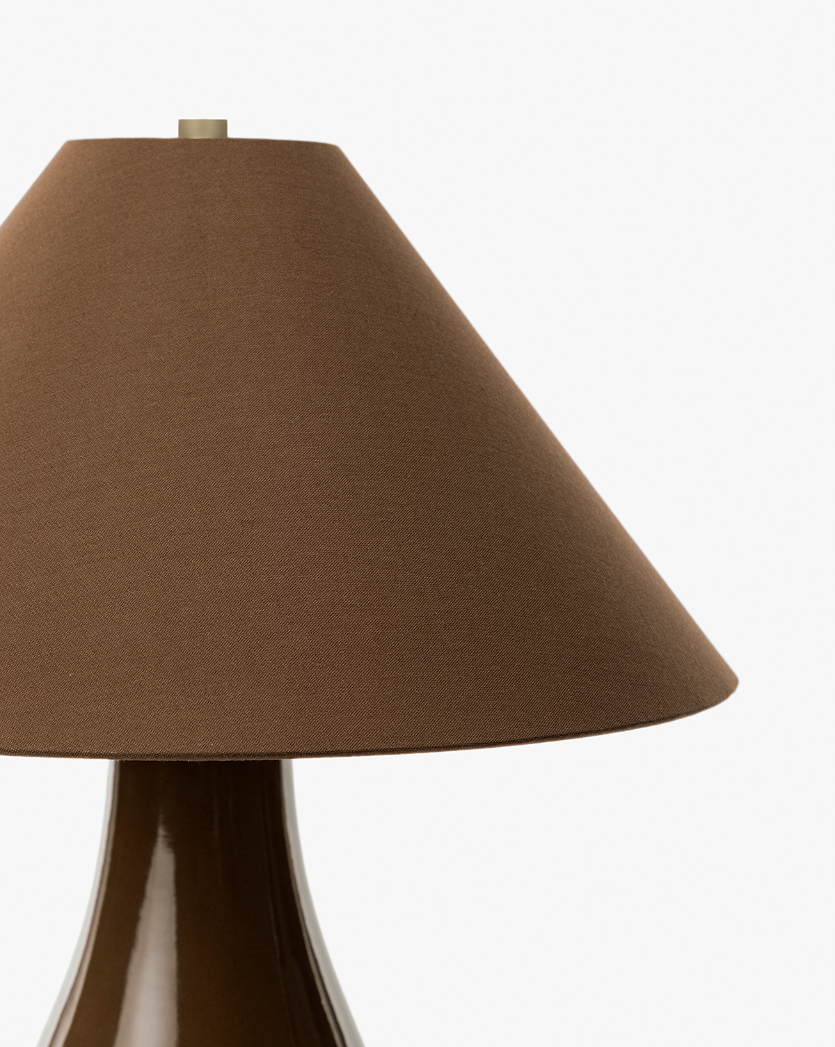 The Irving Table Lamp features a glossy, sculptural brown base and a conical fabric shade, shown in close-up against a plain white background, by Vendixs