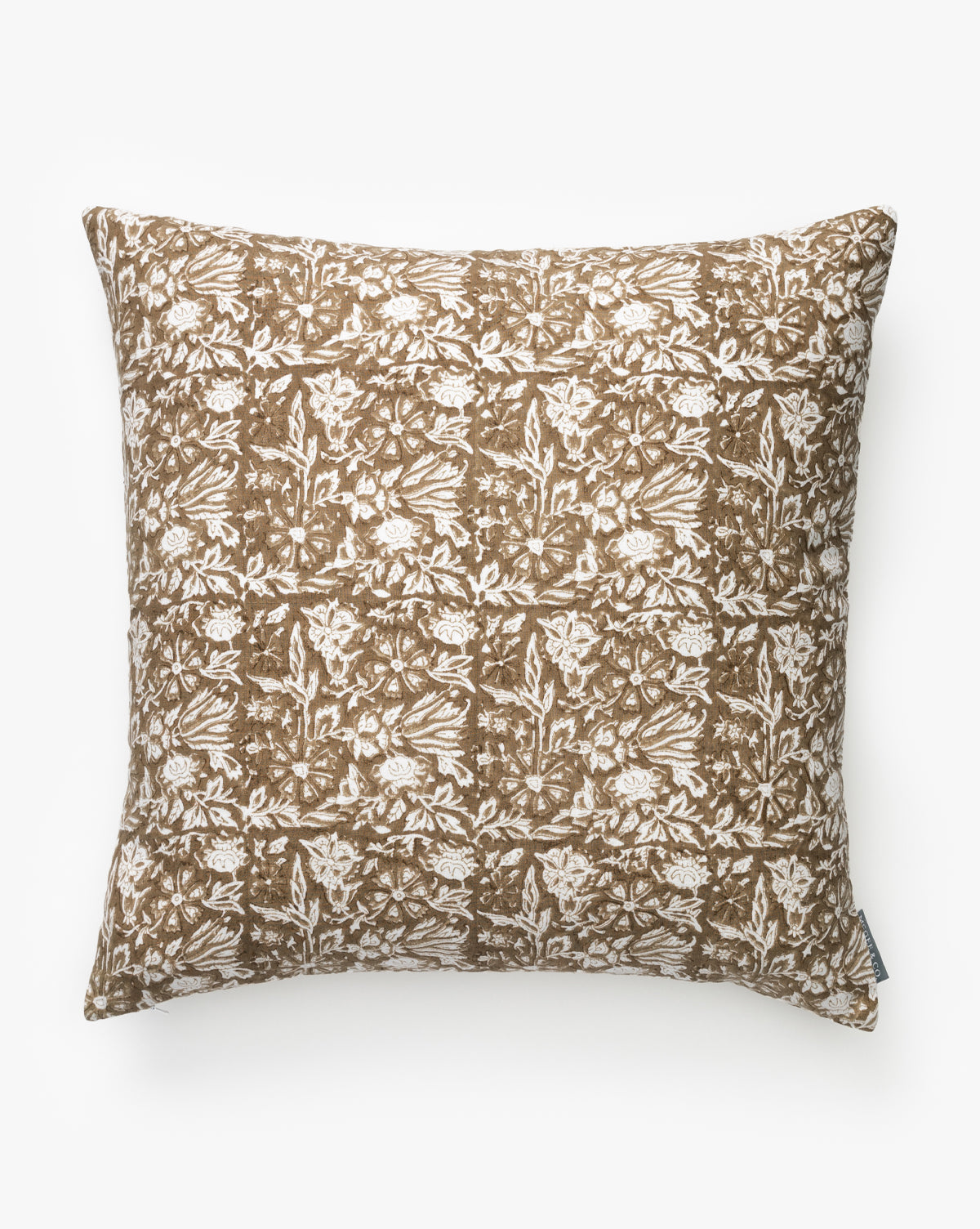 The Jentry Block Print Pillow Cover is a square pillow with a brown background and intricate white floral tile design, soft fabric texture, side tag, and classic block print style, by McGee & Co.