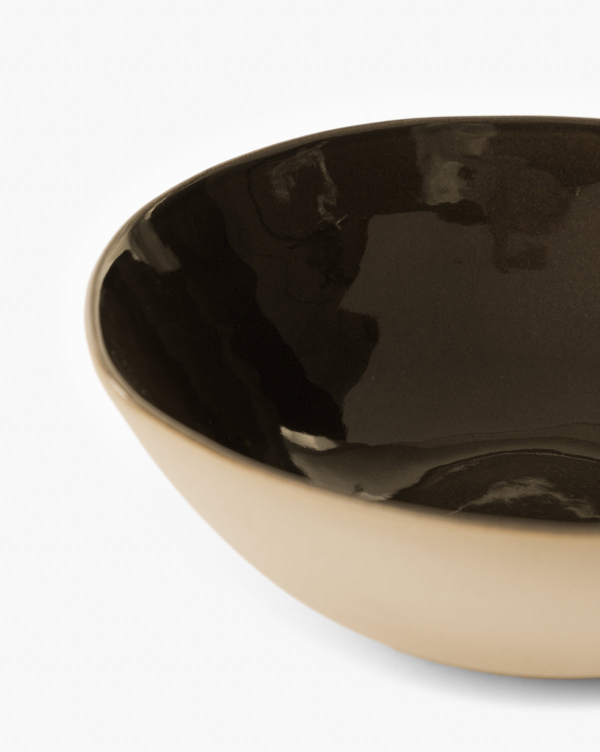 A close-up of the Joanne Serving Bowl featuring a glossy espresso glaze interior and matte light beige exterior, shown against a white background by Vendixs