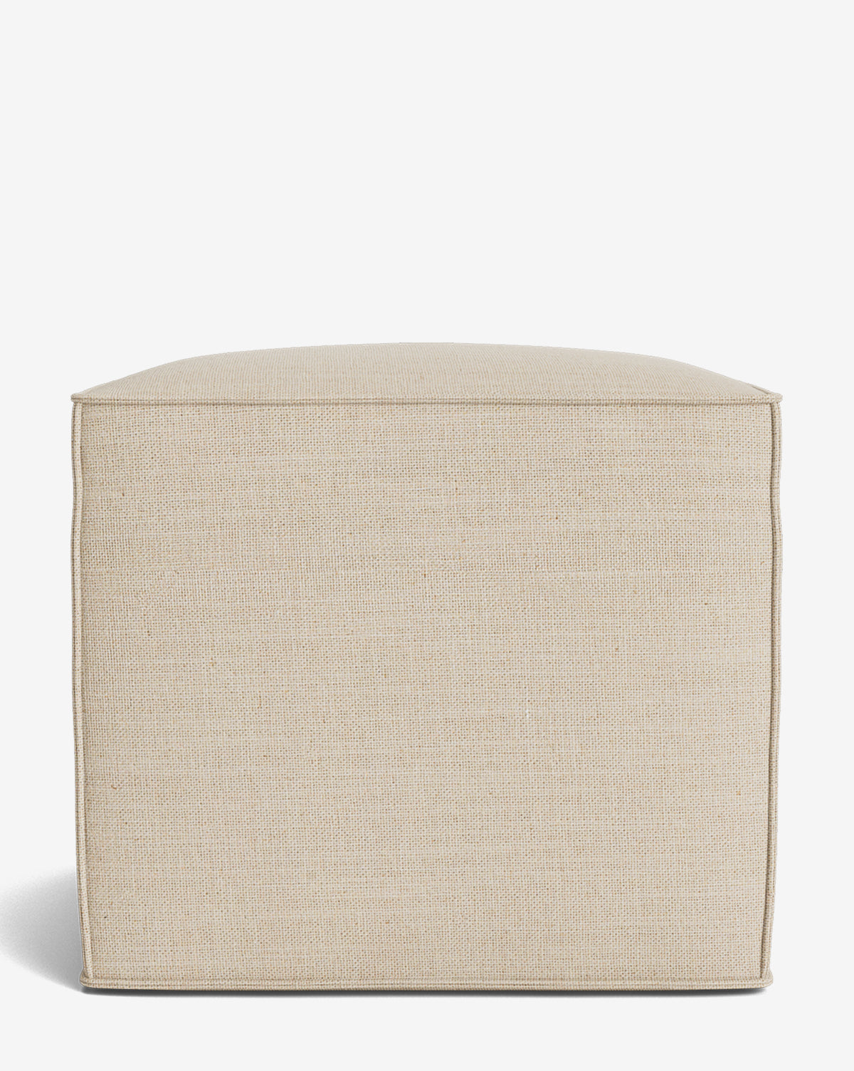The Johannes Cube is a square, beige fabric ottoman with a cushioned seat and clean edges. Its minimalist, modern design is inspired by the Johannes Cube collection and is displayed against a plain white background by McGee & Co.