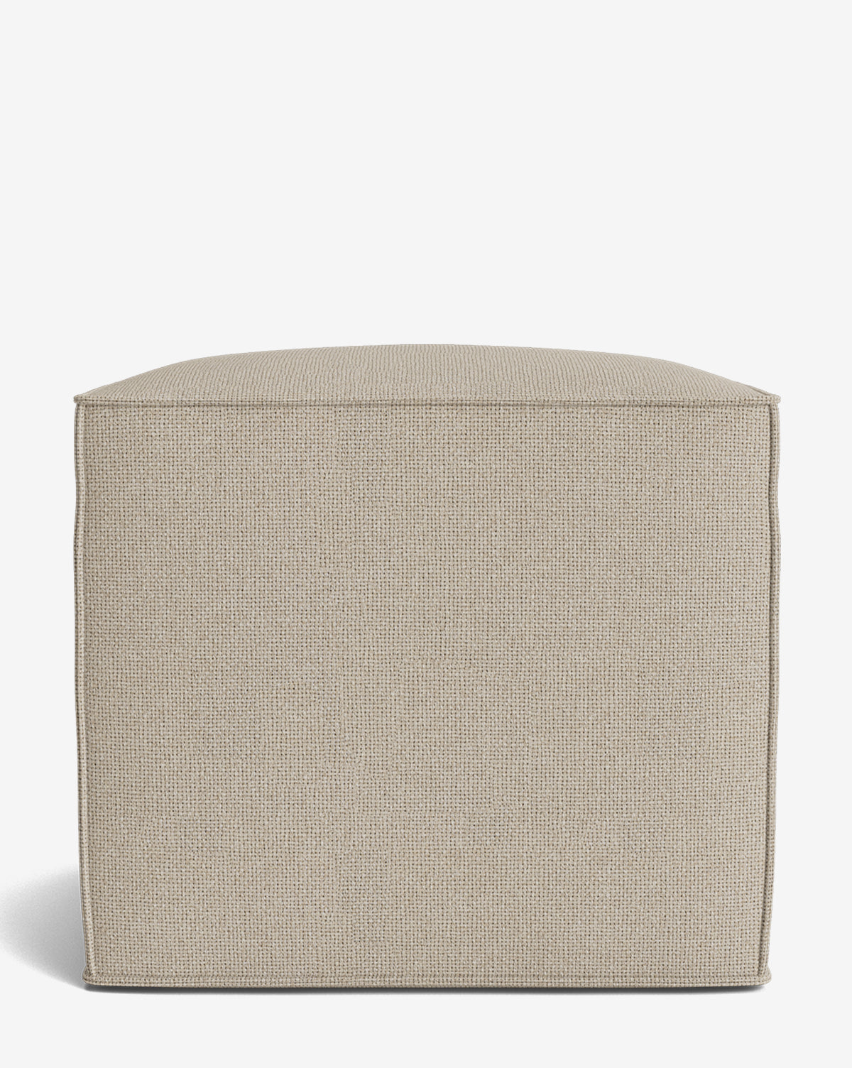 The Johannes Cube is a minimalist, square, beige ottoman with a textured fabric surface, cushioned seat, and defined edges. Its simple, modern design evokes elegance and refinement against a white background, by McGee & Co.