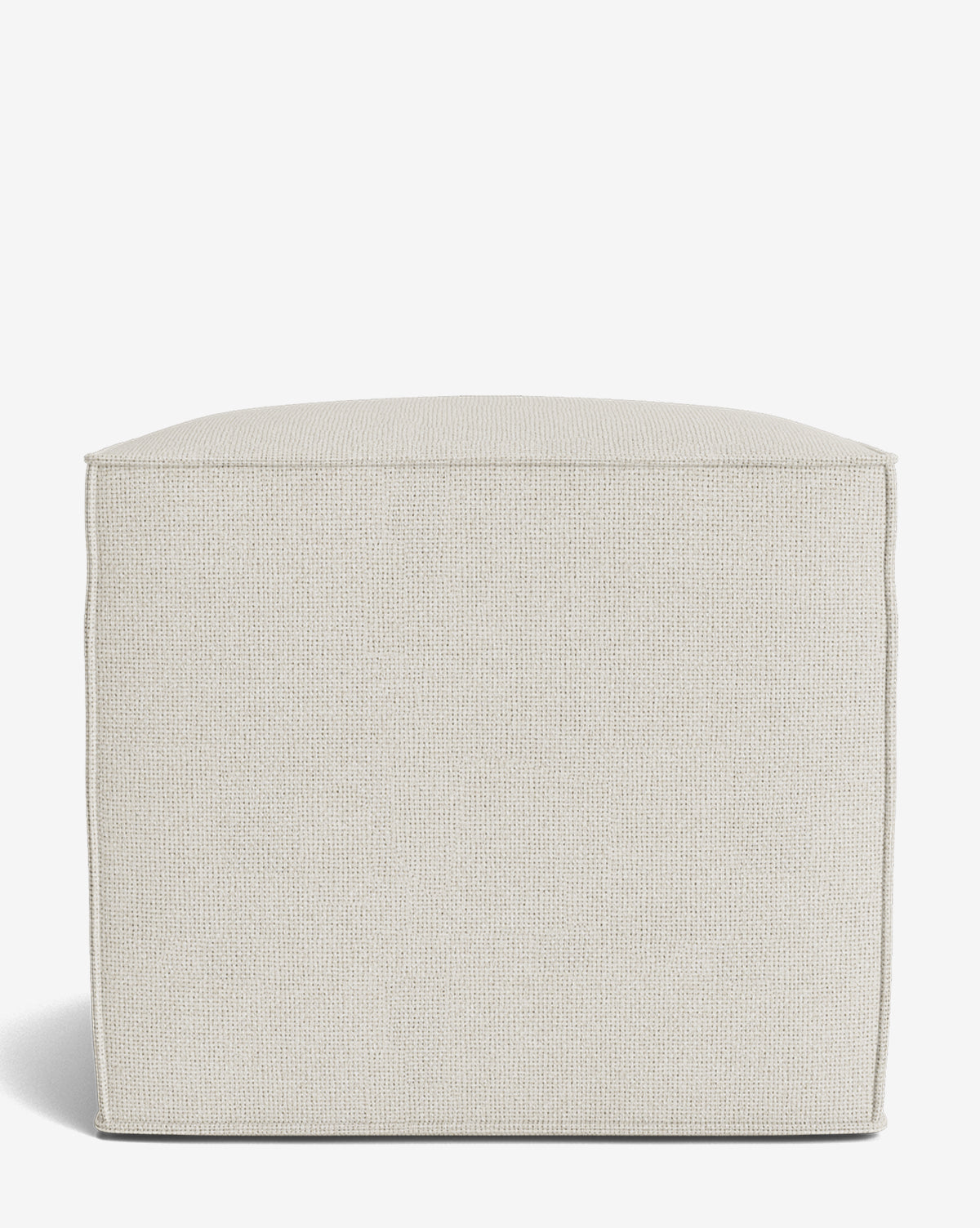 The Johannes Cube is a square, light beige fabric ottoman with a cushioned seat and textured surface. Its simple, boxy design features straight edges and soft corners, making it ideal for contemporary spaces. Shown against a white background by Vendixs