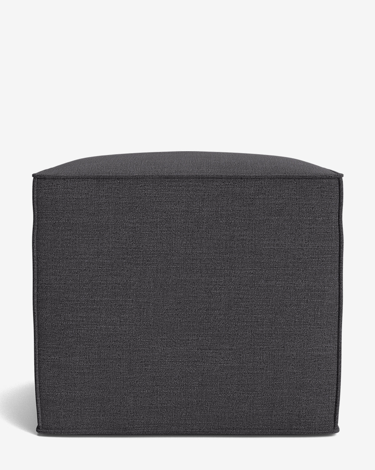 A dark gray, square Johannes Cube ottoman with a cushioned seat and visible edge stitching, shown against a plain white background by McGee & Co.