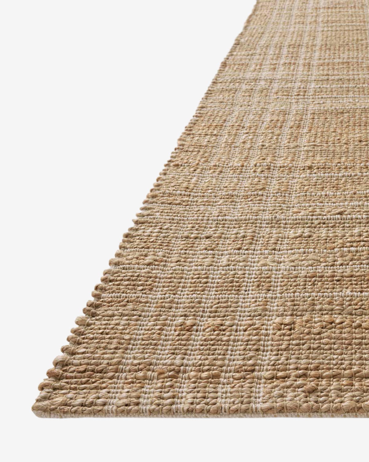 A close-up angled view of the Judy Jute Rug Collection No. 1, a handwoven jute rug with a subtle checkered pattern in beige and tan, set against a white background, by Vendixs