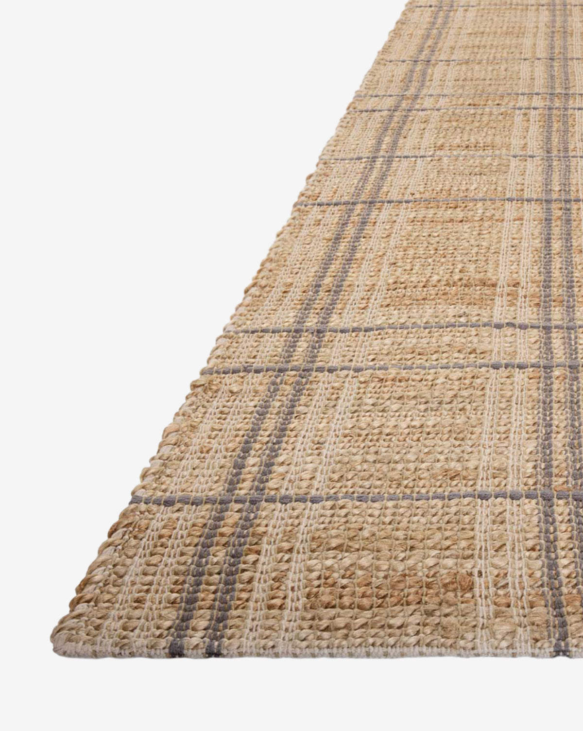 The Judy Jute Rug Collection No. 2 is a handwoven rug with a plaid pattern in natural tan, beige, and gray tones, displayed at an angle on a white background, by Vendixs