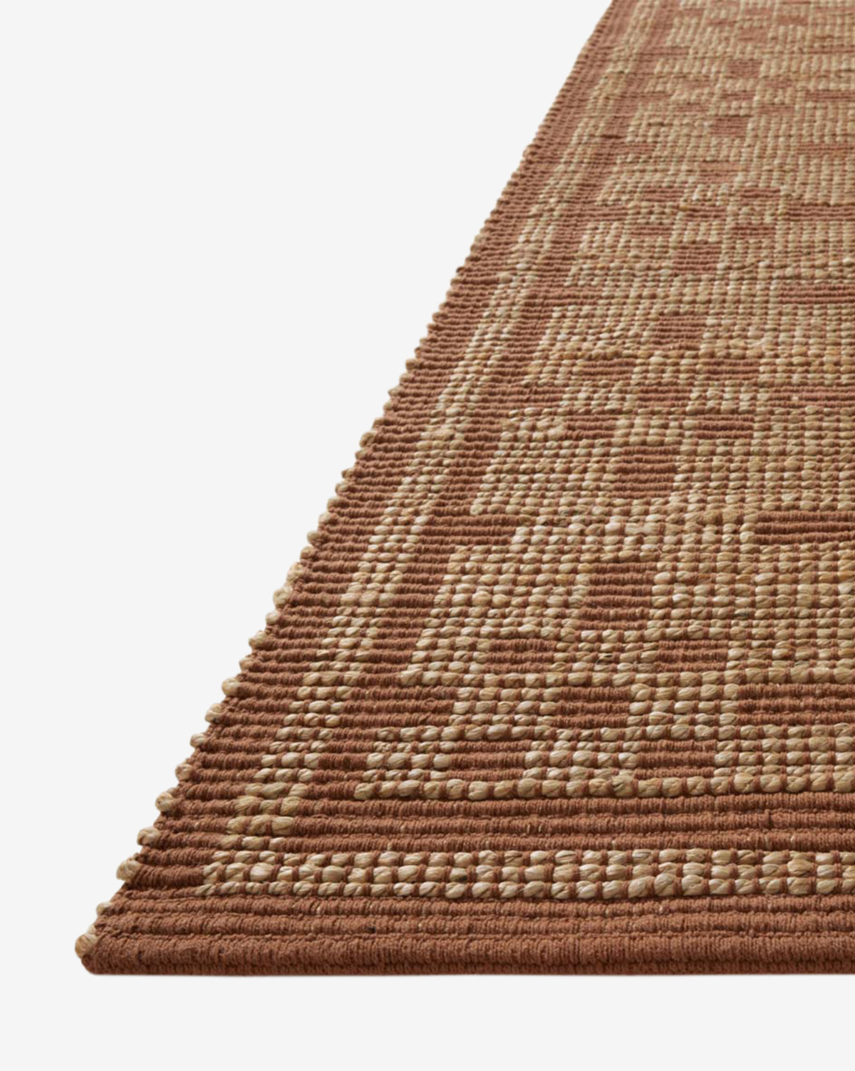A close-up of the Judy Spice Jute Rug Collection No. 7 shows its geometric pattern in brown and beige, along with the textured surface and raised edges that highlight this handwoven neutral rug's detailed craftsmanship, by Vendixs