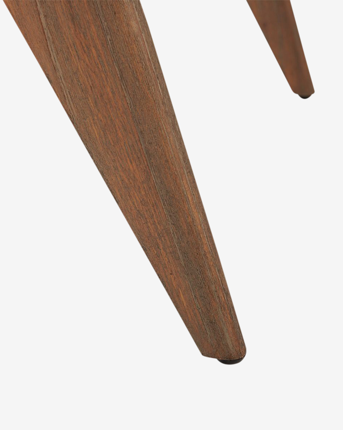 Close-up of a mahogany leg on the Kareen Stool by Villa & House, LLC, featuring a tapered, angular shape with visible wood grain and polished finish, complementing its hand-woven cane seat against a white background. Vendixs