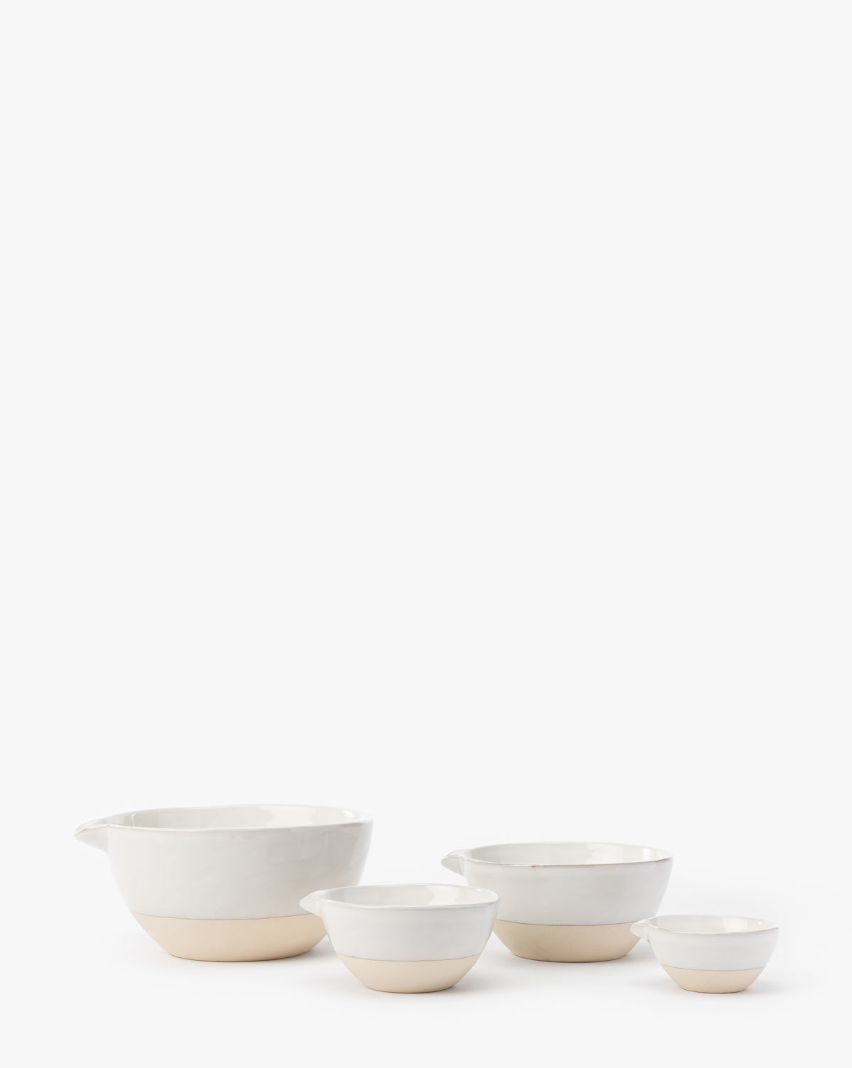 The Karina Stoneware Batter Bowls (Set of 4) are shown in a row on a white background. Each white bowl features a subtle beige base, and the largest bowl on the left has a spout, evoking classic vintage baking charm, by Vendixs