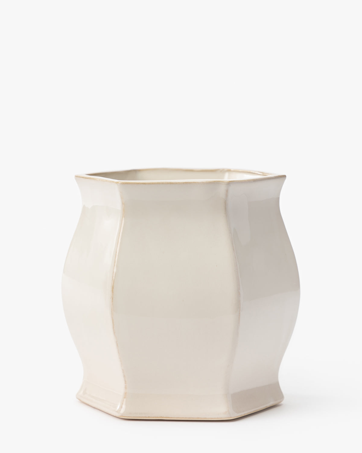 The Kasha Cream Pot by Napa Home & Garden features a glossy, cream ceramic finish, soft curves with gentle vertical ridges, and a flared hexagonal shape for an artisan-quality minimalist look by Vendixs