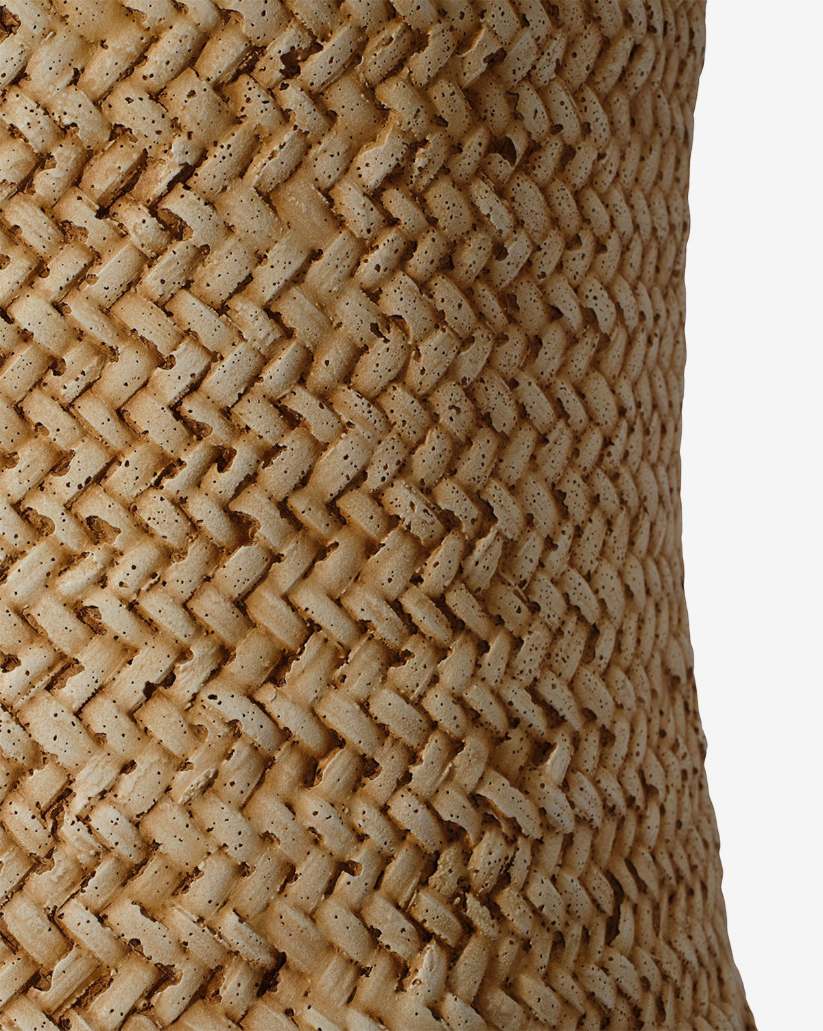 Close-up of the Keira Stool by Made Goods, featuring a woven, textured surface crafted from natural light brown fibers in a diagonal zigzag pattern, showcased against a plain white background. Vendixs