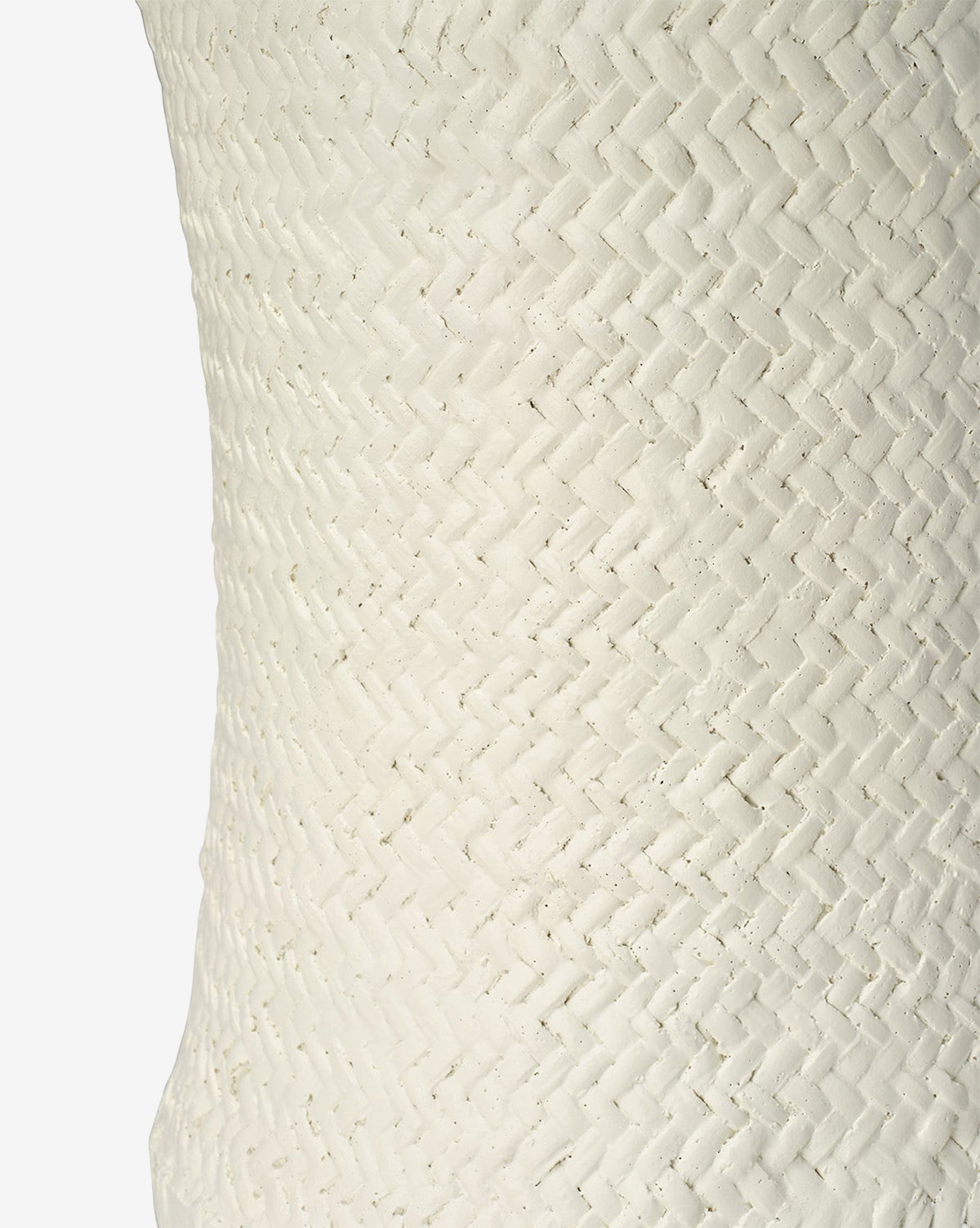 Close-up of the Keira Stool by Made Goods, featuring a textured white surface with a diagonal woven herringbone pattern inspired by basket weaving. The simple background highlights the stool’s tactile and visually striking design. Vendixs