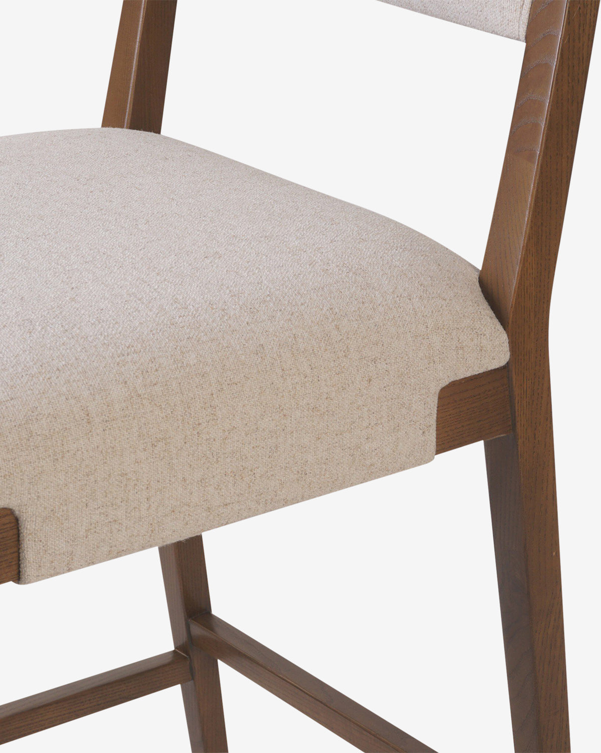 Close-up of the Four Hands Kennebec Stool, featuring a light beige performance fabric seat and backrest on an ash frame. The white background highlights the stool’s design and craftsmanship. Vendixs