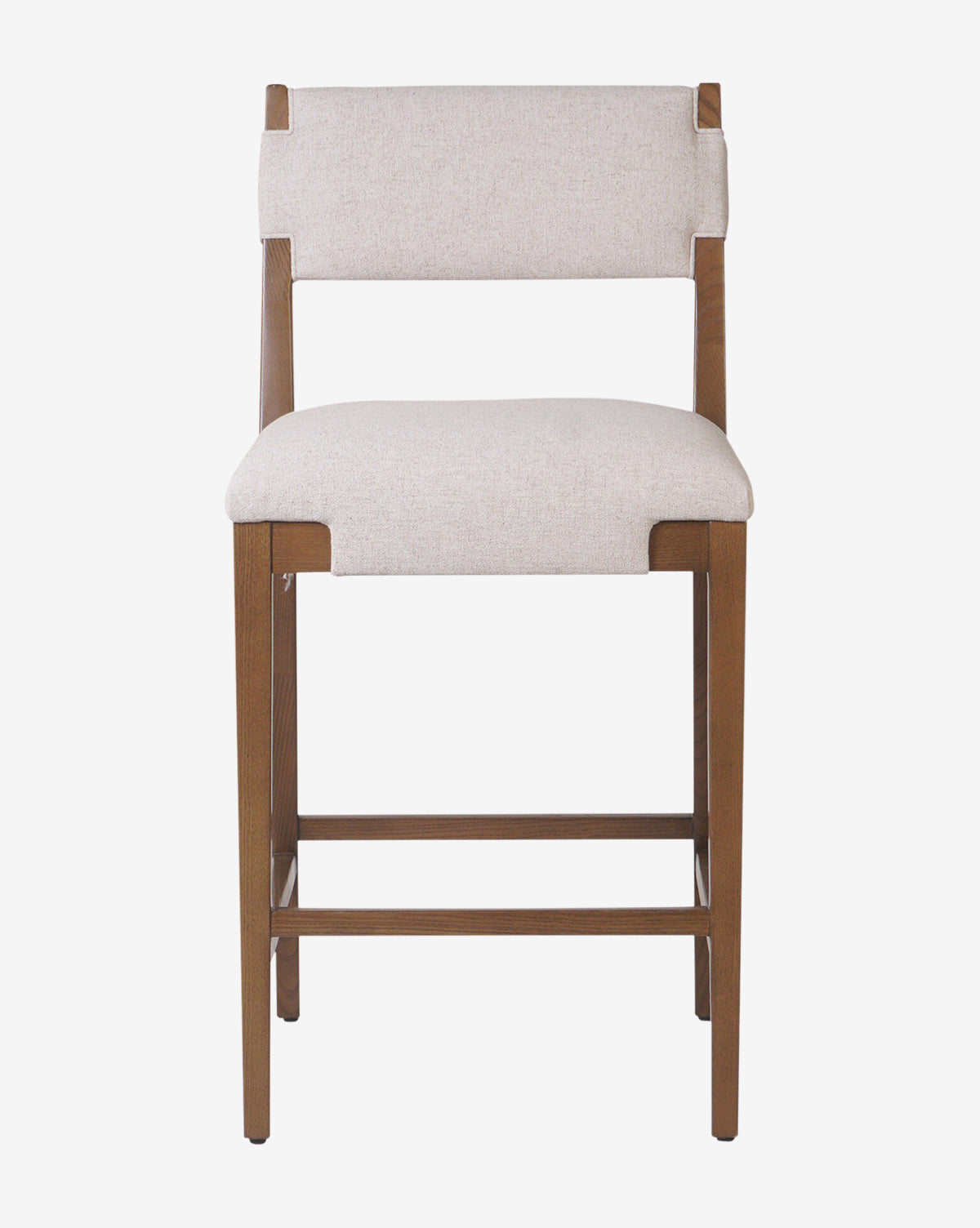 The Kennebec Stool by Four Hands is a wooden kitchen stool with straight legs and footrests, featuring a rectangular design and light beige performance fabric upholstery on the seat and backrest, shown against a plain white background. Vendixs