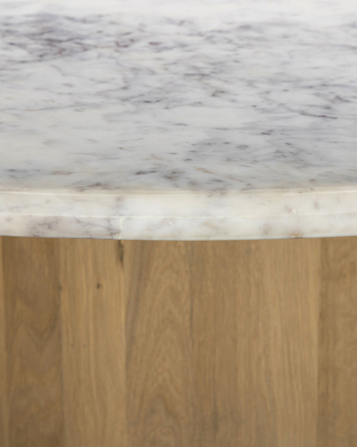 The Kinlaw 60 Round Dining Table features a white marble tabletop with gray veining and a light solid oak base, by Vendixs