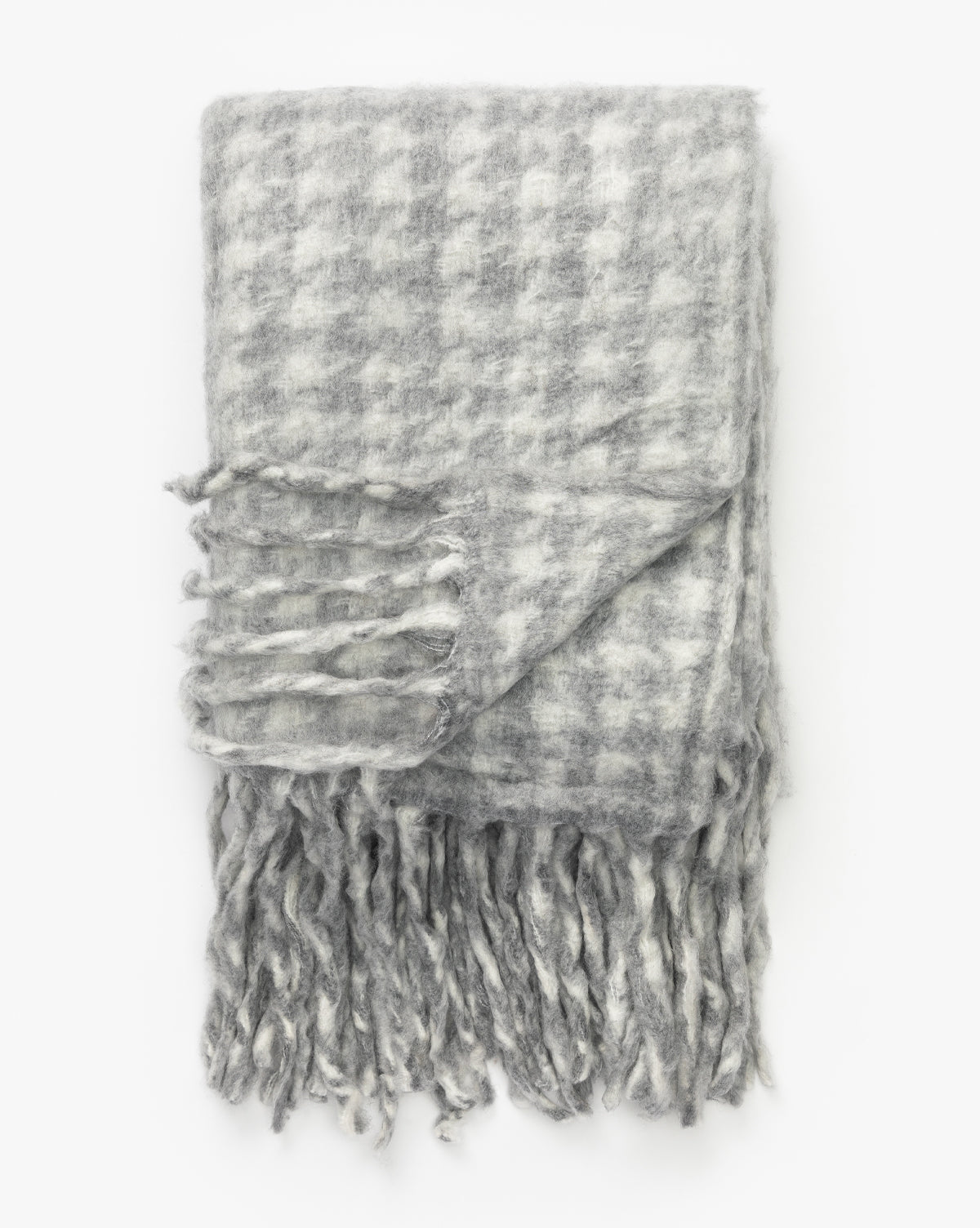The Indaba Kirsley Houndstooth Throw in gray and white, with fringed ends, adds a touch of luxury to any space—perfect decor for your home. Vendixs