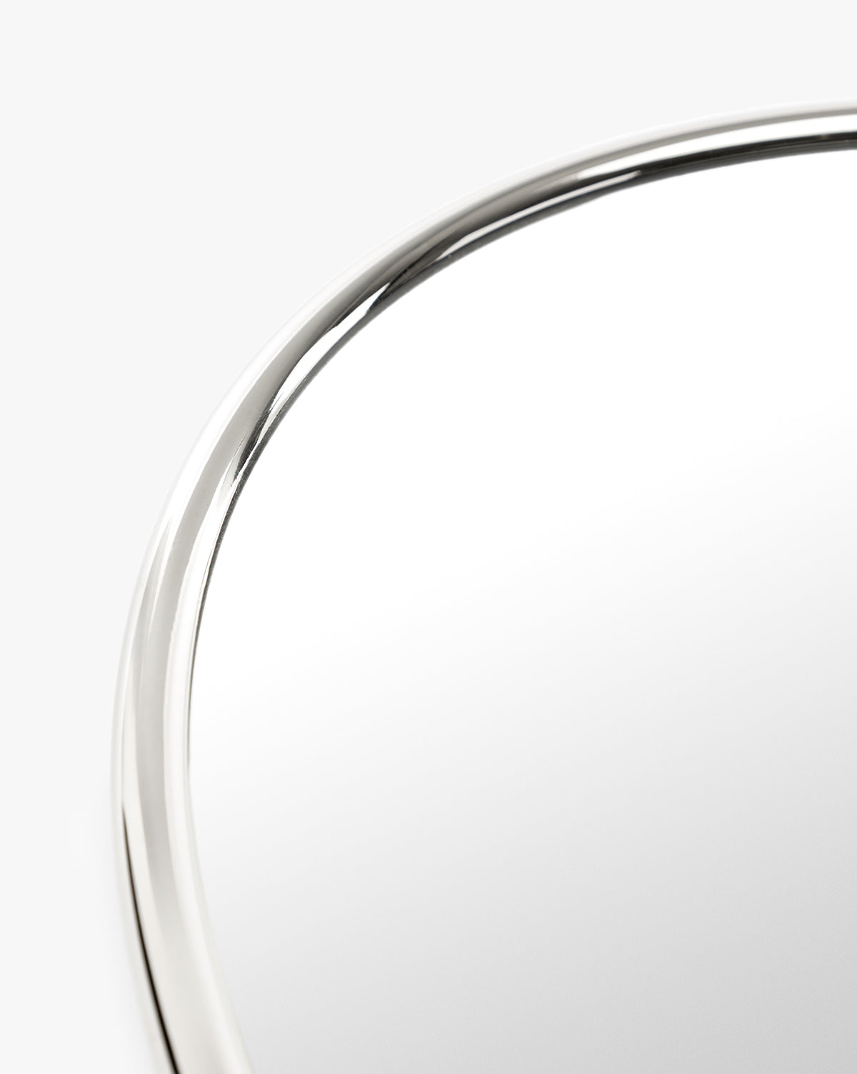 A close-up of the Kitson Oval Mirror highlights its sleek, antique brass oval frame set against a plain white background, by Vendixs