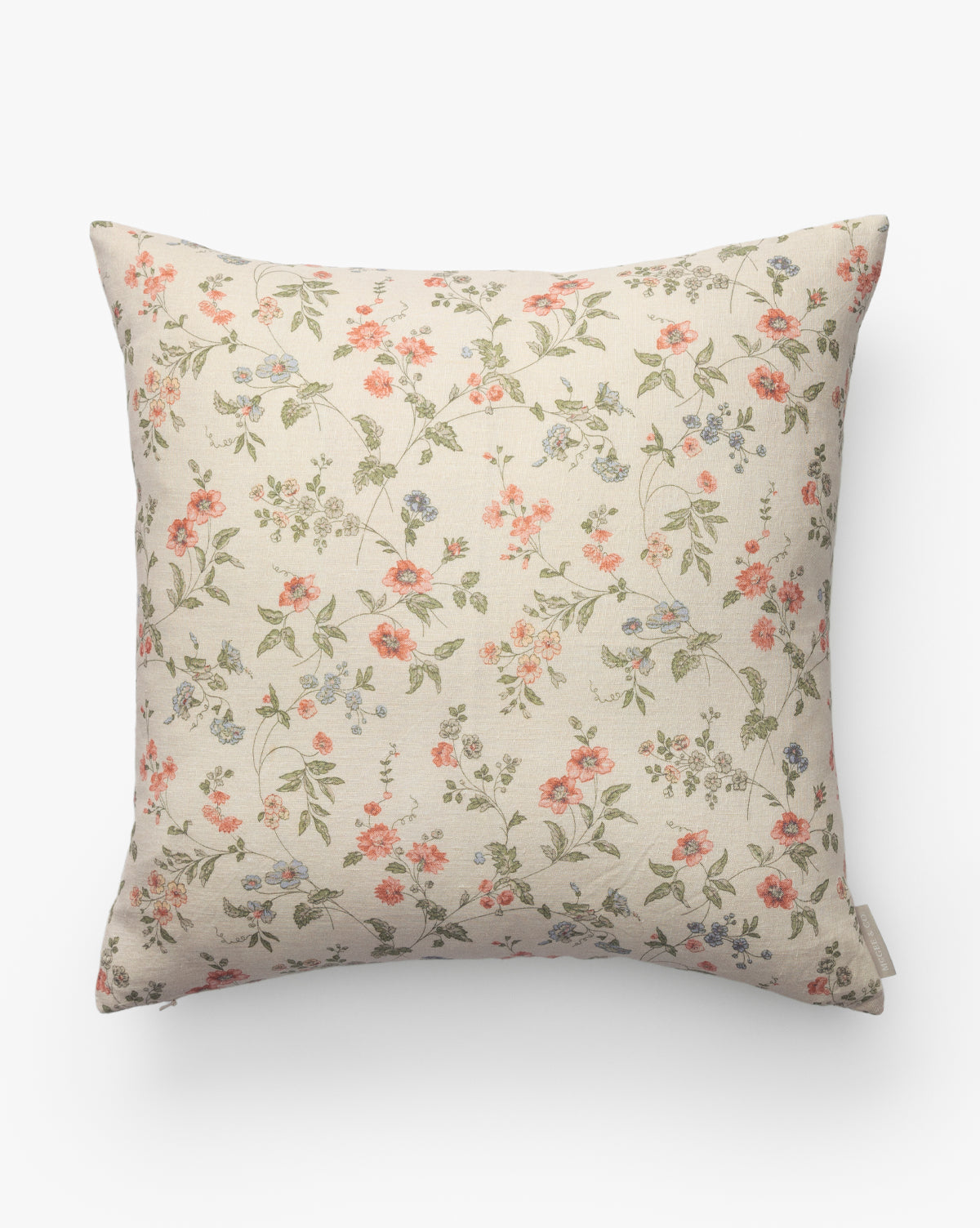 The Kittredge Floral Pillow Cover features a cream background with a ditsy floral pattern in pink, orange, and blue with green leaves, bringing simple, vintage-inspired elegance to any space, by Vendixs