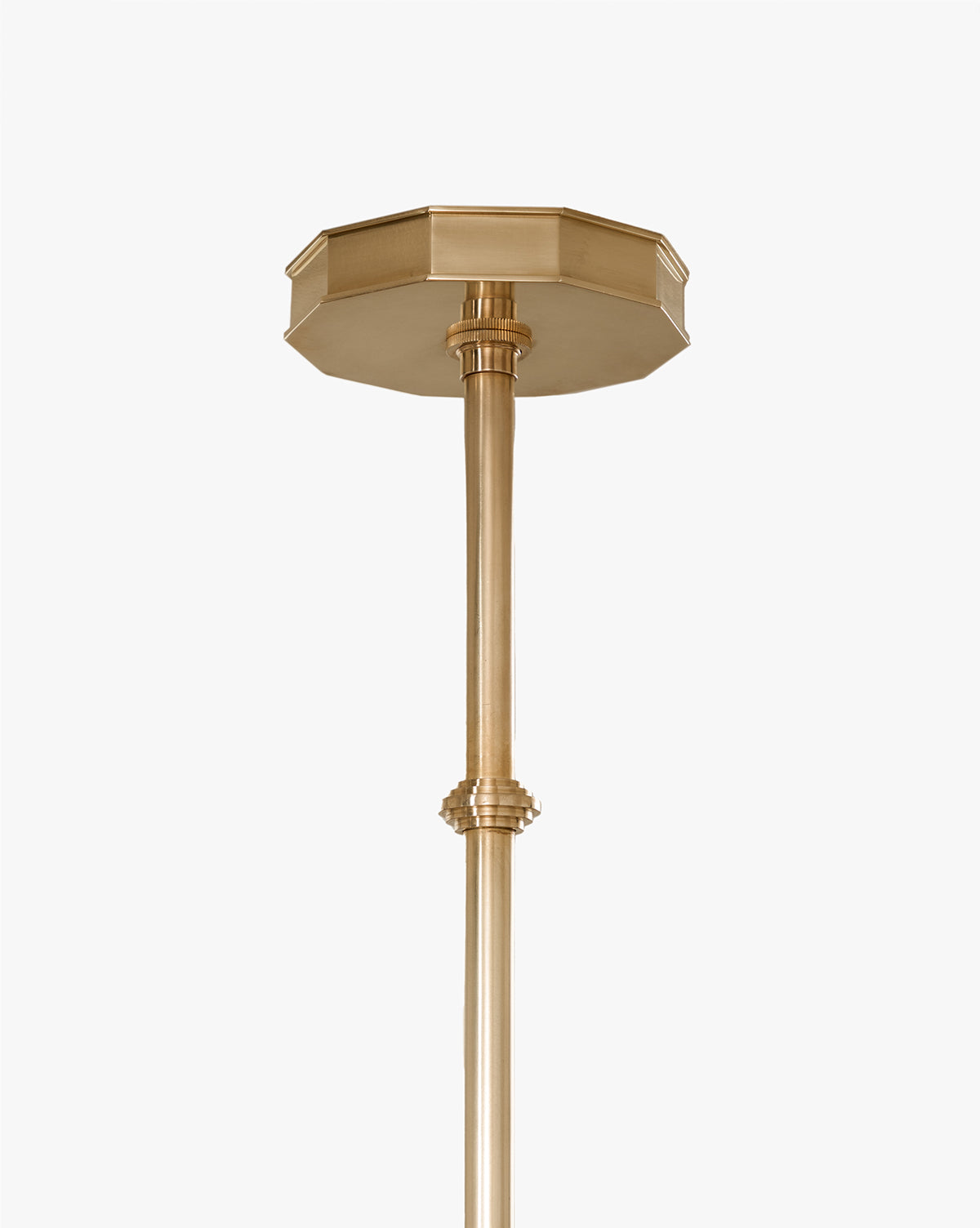 A close-up of the Knightley Chandelier shows its brass ceiling mount with a decorative octagonal canopy and straight rod, evoking an antique look, set against a plain white background, by Vendixs