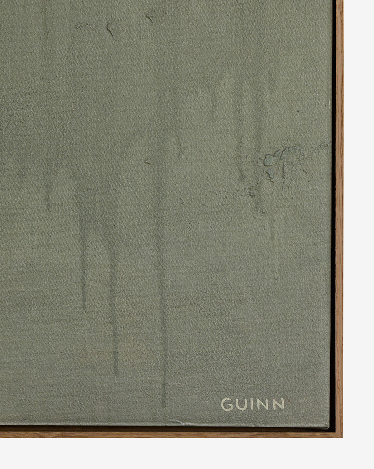 A close-up of Knowledge Of The Stream by Tyler Guinn shows a greenish-gray textured canvas with faint paint drips, subtle surface imperfections, and the artist’s white signature at the bottom right, bordered by a thin white oak frame by Vendixs