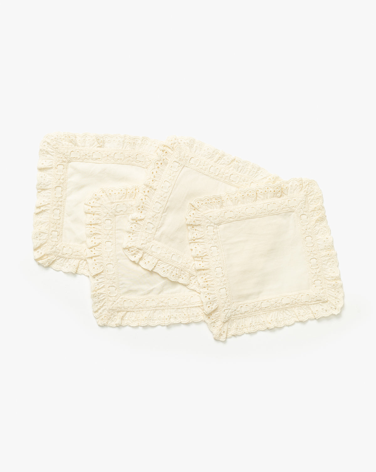 The Lace Trim Cocktail Napkins (Set of 4) are stacked against a white background, each with vintage-inspired scalloped lace borders—an elegant choice for your table decor, by Vendixs