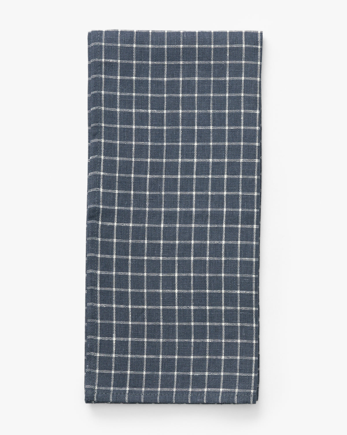 The Lancaster Linen Tea Towel, featuring a neatly folded navy and white check design, is displayed on a plain white background—a timeless kitchen staple, by Vendixs