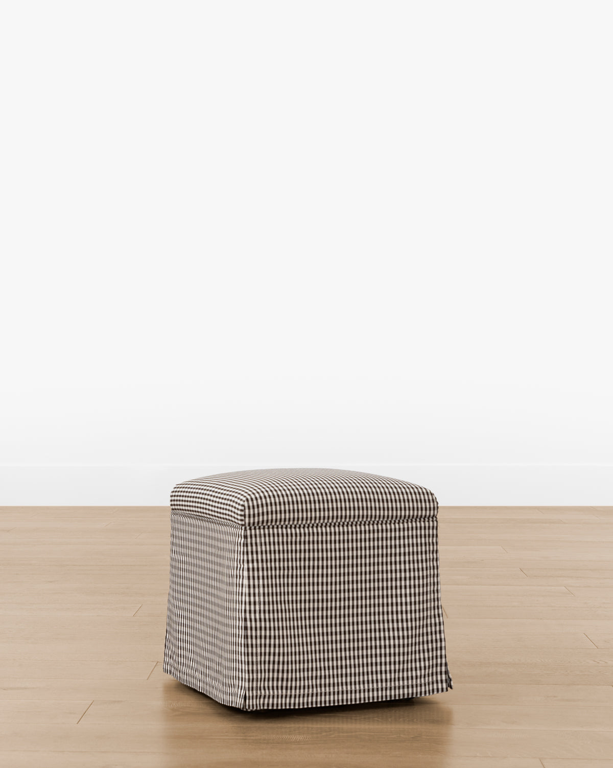 The Makerspalm Latimer Ottoman (Ready to Ship) features a black and white gingham checkered cover, crafted from high-quality fabrics—perfect as a functional accent piece for any room. Vendixs