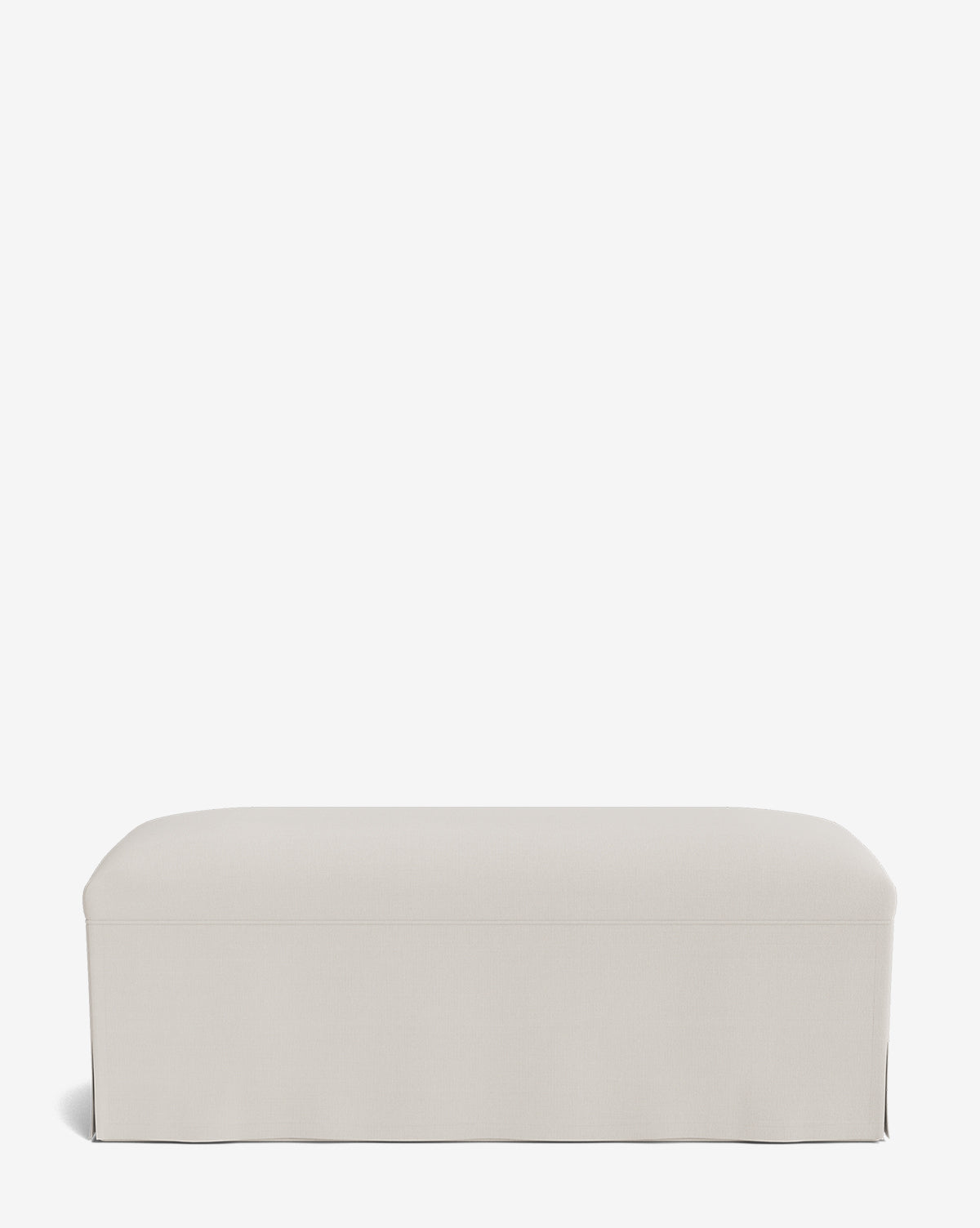 The Latimer Bench is a rectangular bench with light beige upholstery, a smooth, simple design, and a tailored skirt at the base, shown against a plain white background by McGee & Co.