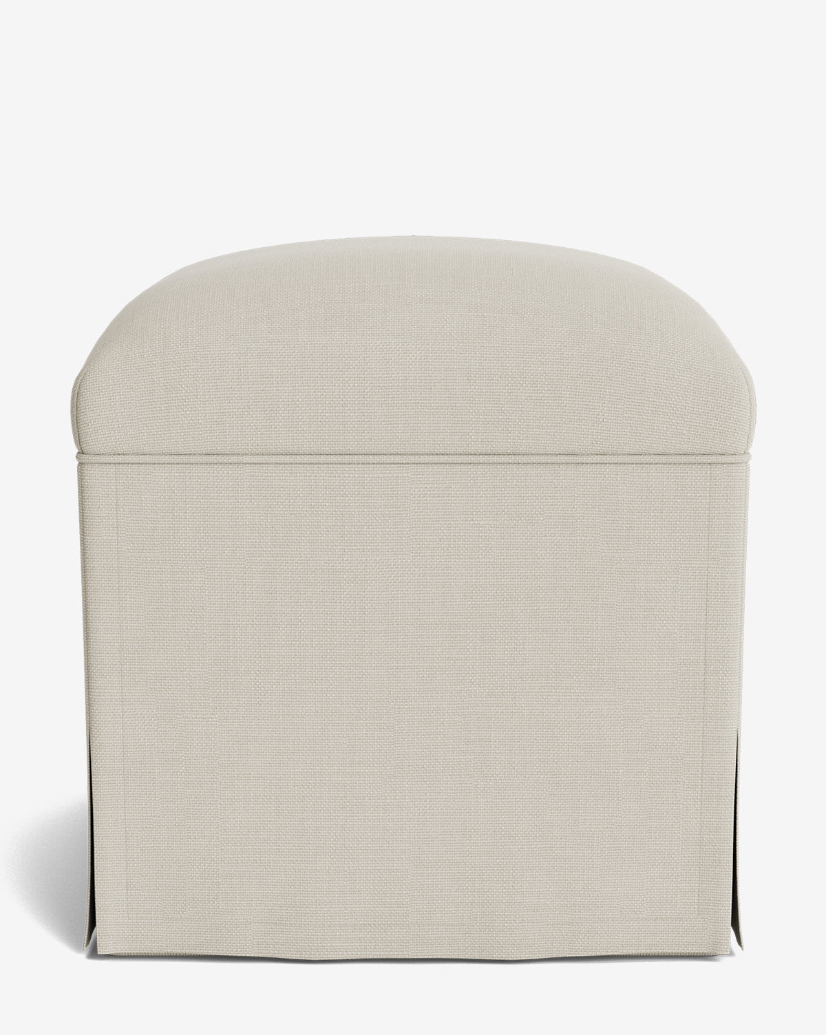 The Makerspalm Latimer Ottoman showcases beige upholstery in high-quality fabric, with a rounded top and tailored skirt, displayed against a plain white background by Vendixs