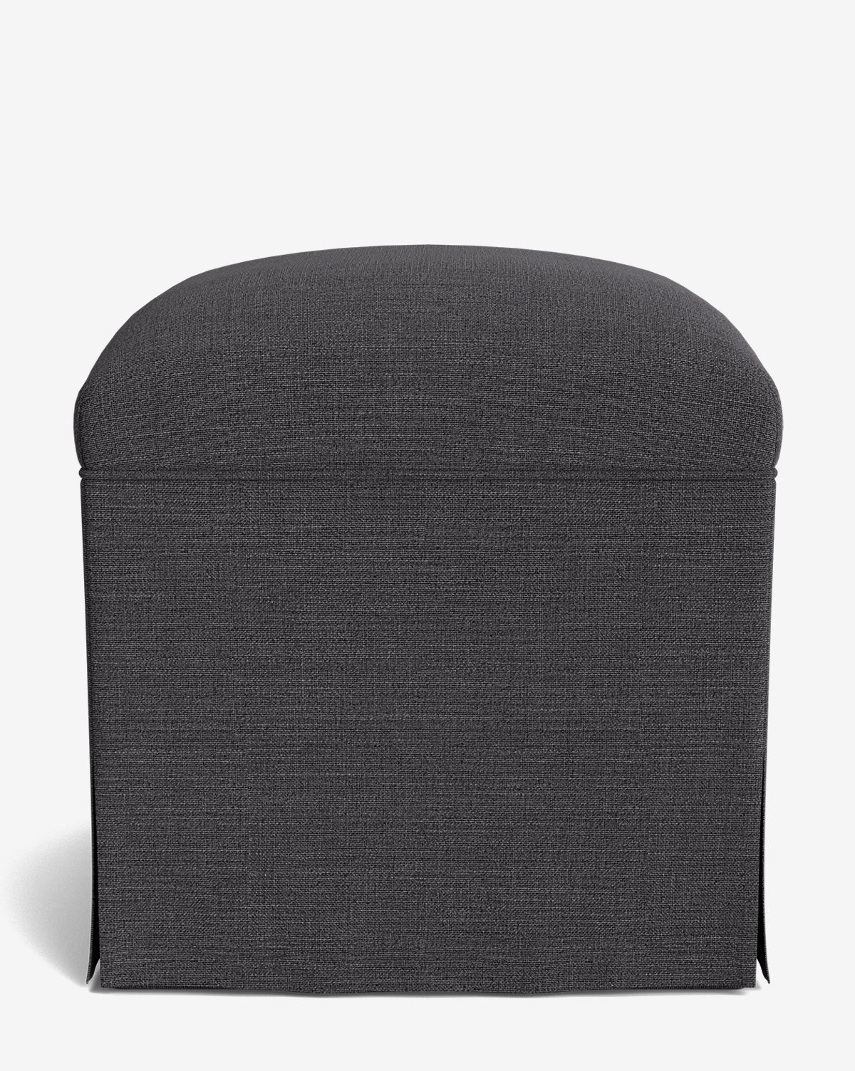 The Makerspalm Latimer Ottoman showcases a dark gray, rectangular form with a rounded cushioned top and skirted high-quality fabric cover, all set against a plain white background by Vendixs