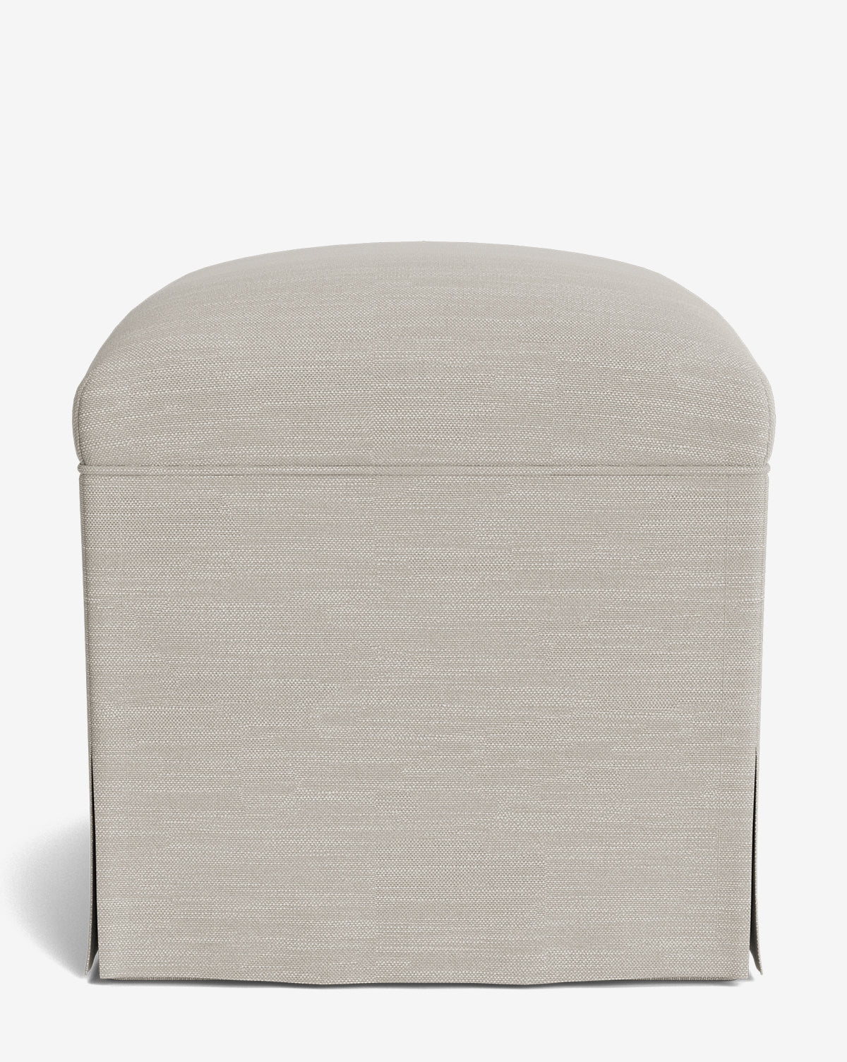 A Makerspalm Latimer Ottoman in beige, featuring high-quality fabric upholstery, a rounded top, and a skirted base, is displayed from the front against a plain white background by Vendixs
