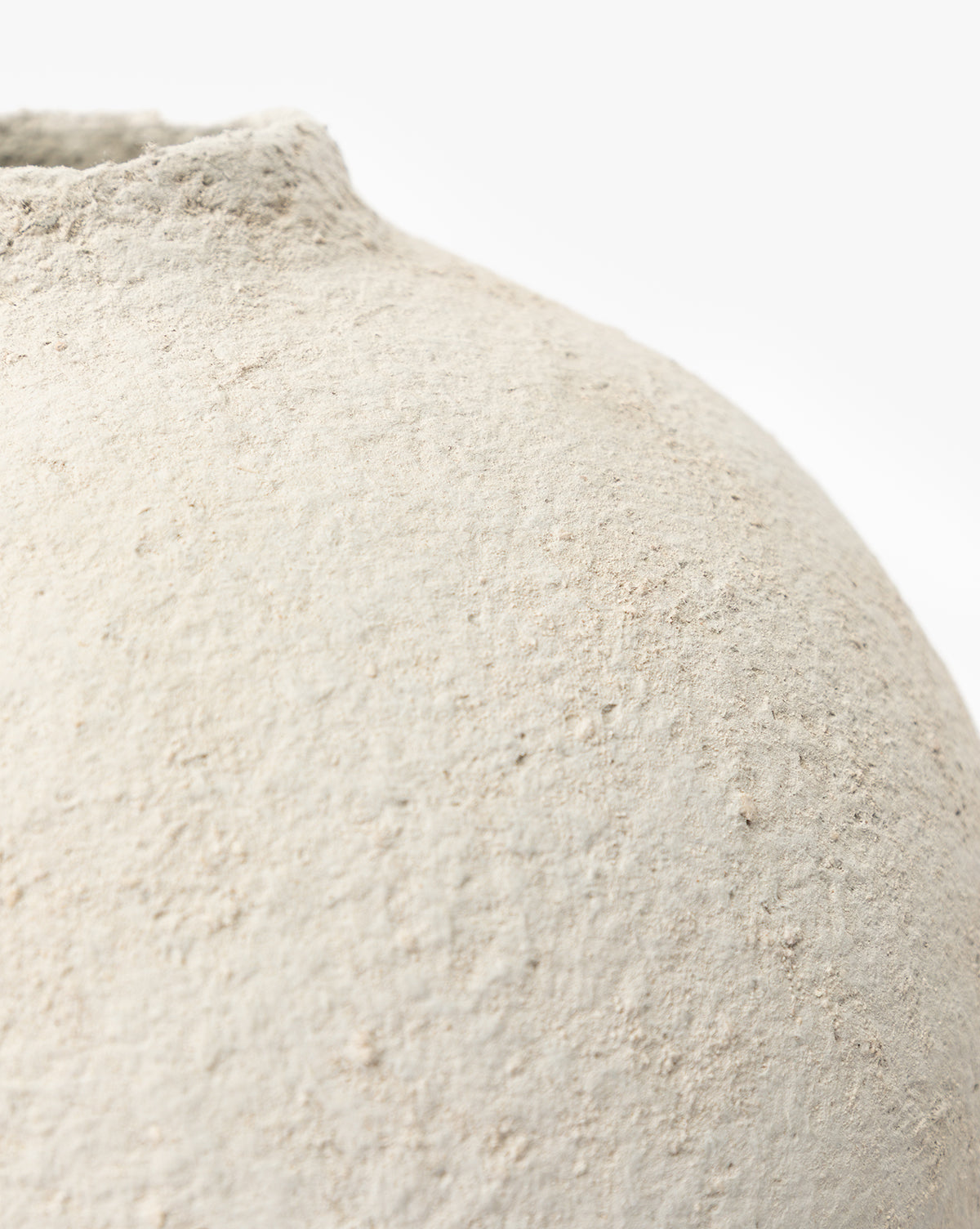 Close-up of the LeBeau Paper Mache Vase, featuring a textured off-white surface and an uneven, rounded shape that emphasizes its organic charm against a plain white background, by Vendixs