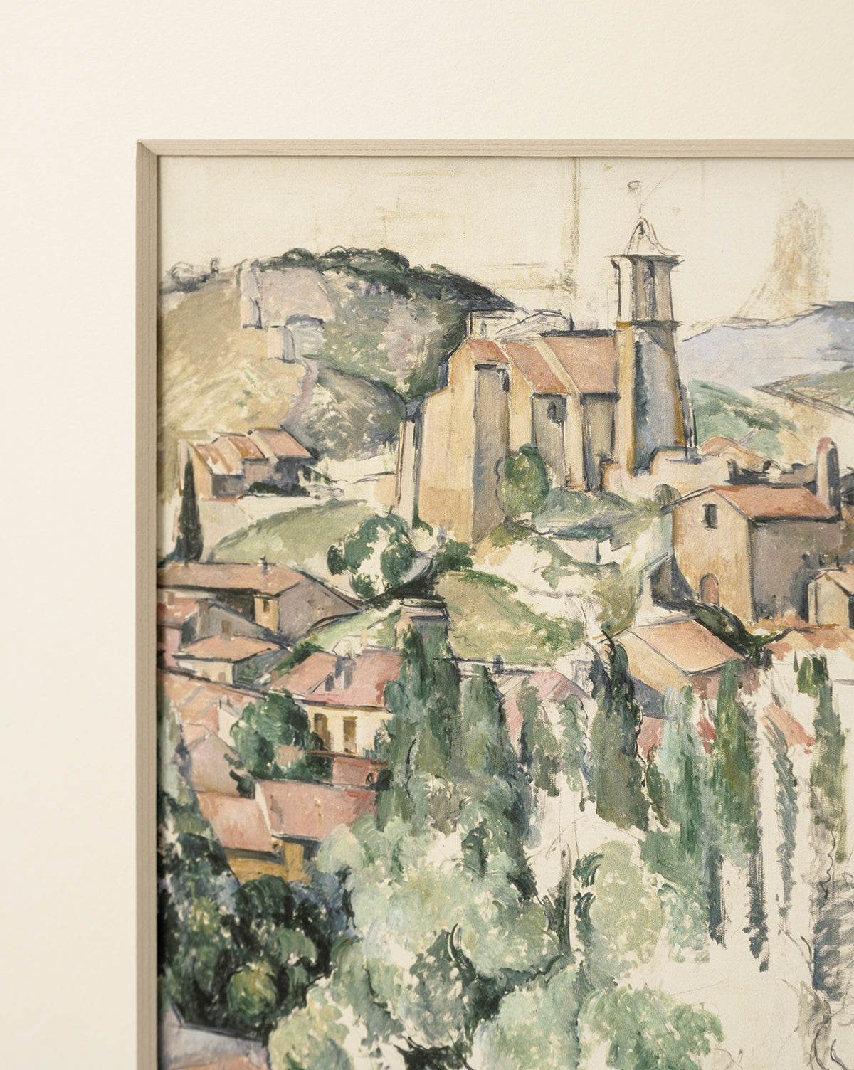 Le Village, a giclee print of a painted landscape, features a hillside village with a stone church and red-roofed houses among green hills and trees under a light sky, presented in a natural woodgrain frame, by Vendixs
