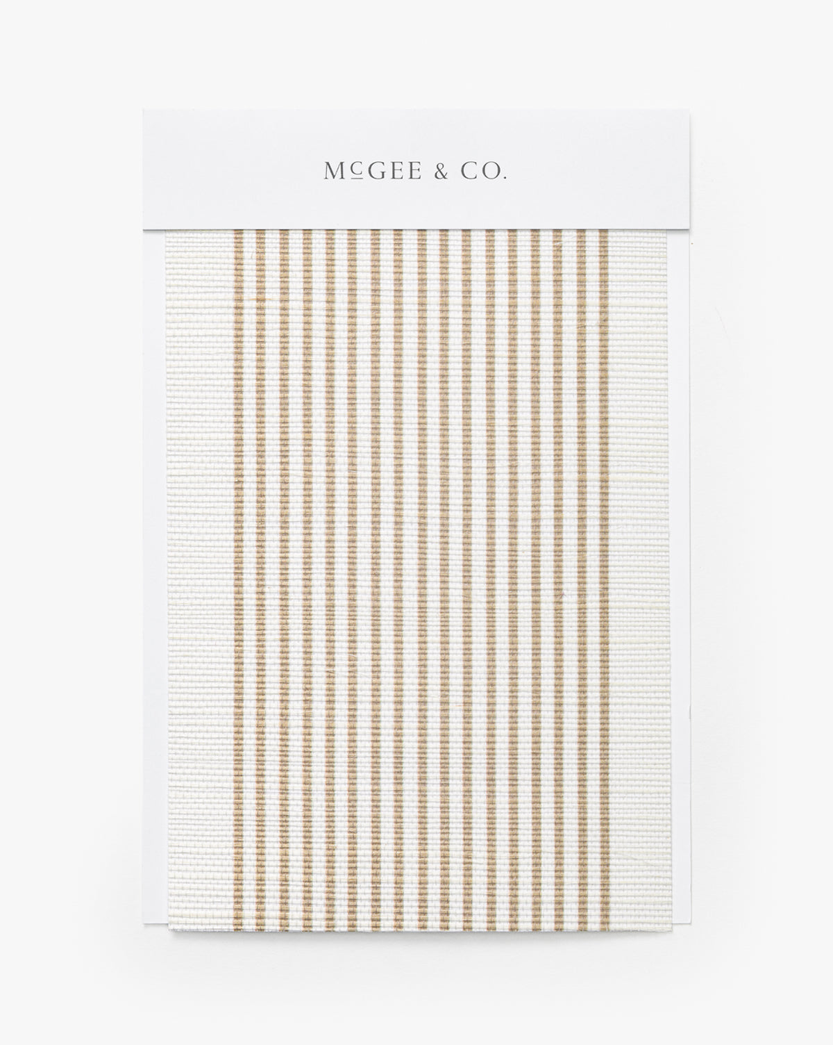 A Leah Striped Sisal Wallpaper Swatch by York Wallcoverings features thin, vertical beige stripes on a white background, resembling modern stripe wallpaper, displayed on a branded card by Vendixs