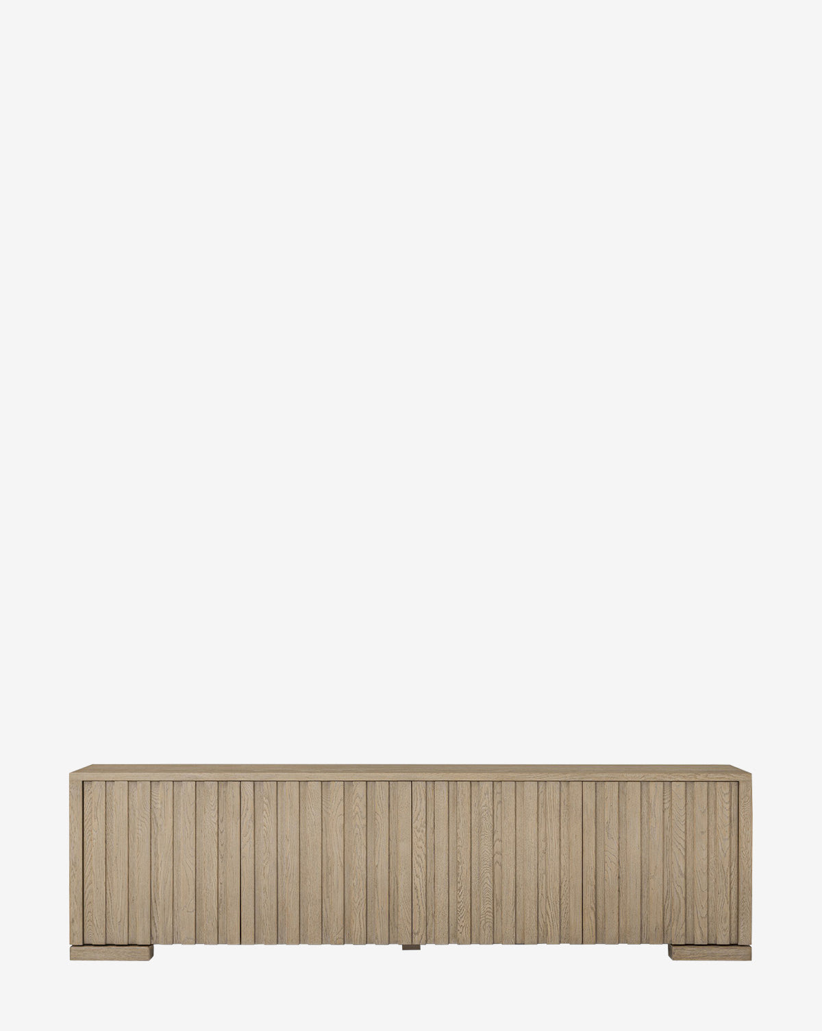 The Leith Console is a contemporary wooden storage cabinet with a light natural finish, vertical slatted front, and small block feet, shown against a plain white background by McGee & Co.