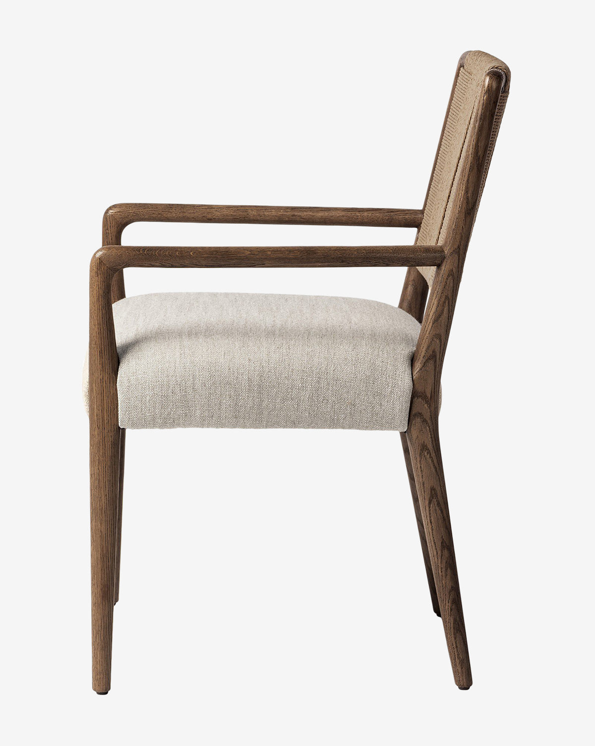 Side view of the Leola Dining Armchair, featuring a modern oak frame and light beige upholstered seat and backrest. Clean lines and minimalist design showcase the elegance of this wooden armchair, by Vendixs
