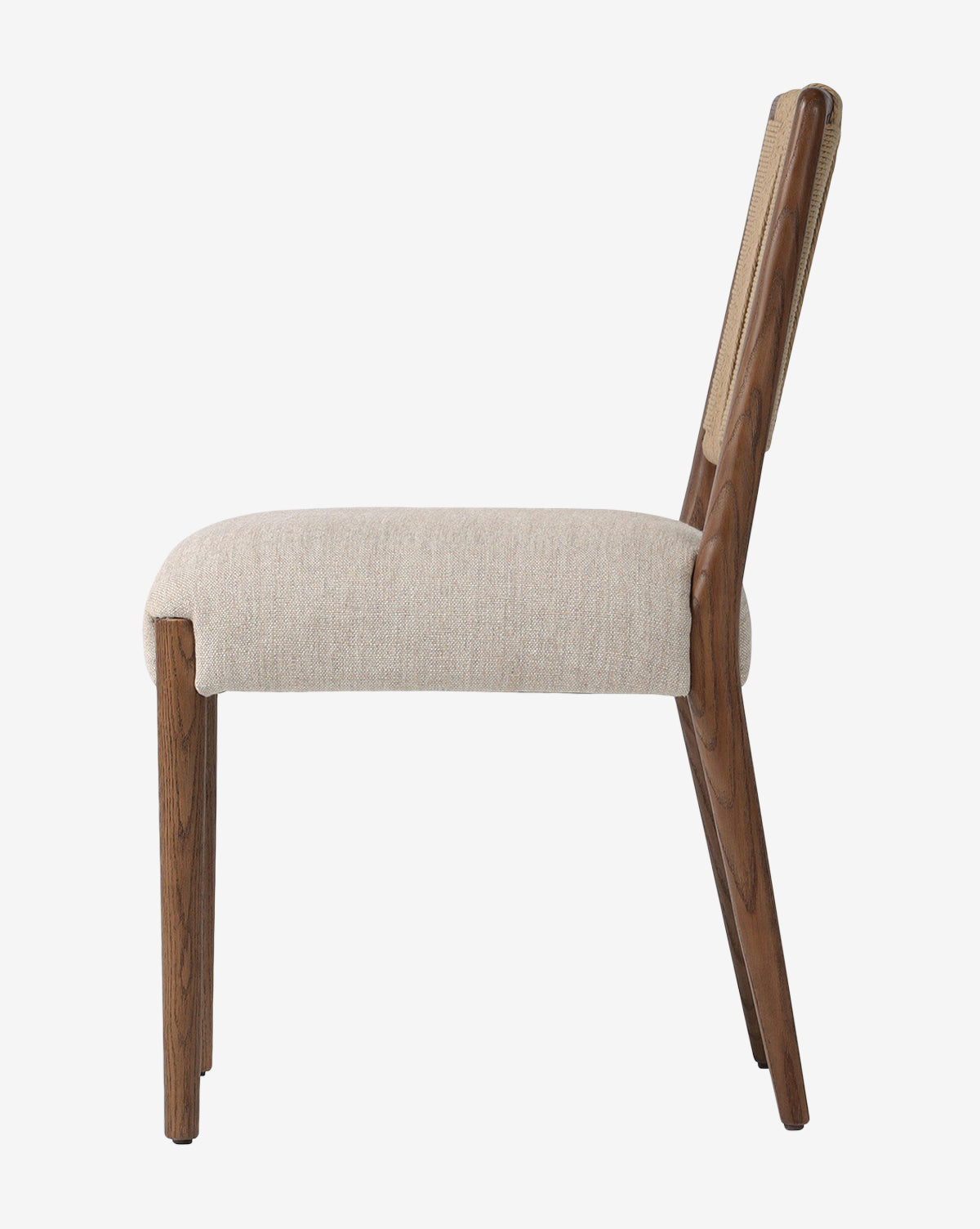 Side view of the Leola Dining Chair featuring a modern oak frame, angled wooden legs, and a light beige upholstered seat and backrest, photographed against a plain white background by Vendixs