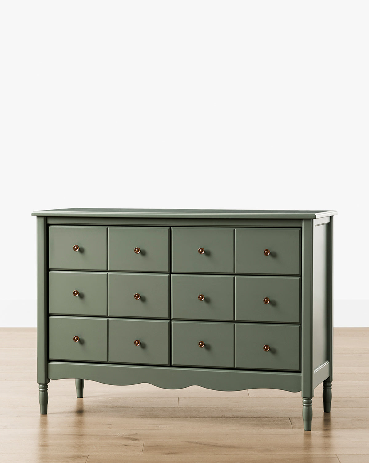 The Liberty 6-Drawer Assembled Dresser, made from sustainable pine wood with round knobs and turned legs, stands on a light wooden floor against a plain white background, by Vendixs