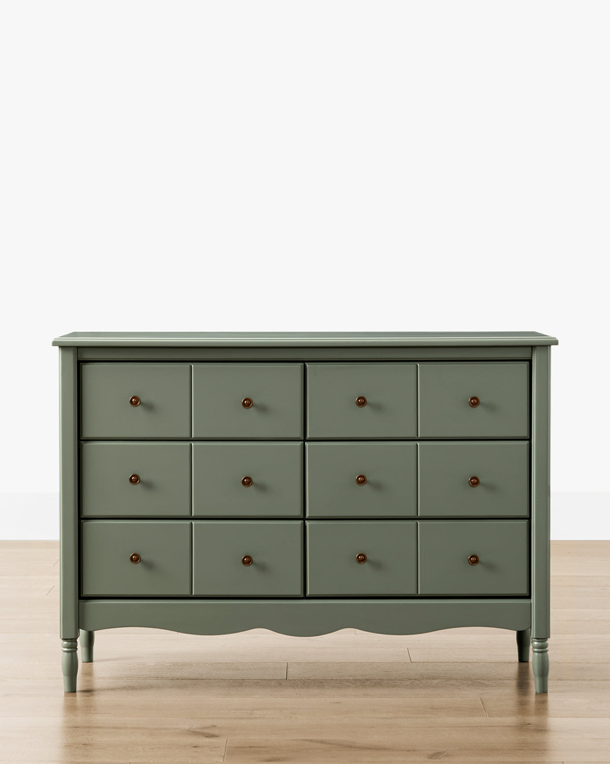 The Liberty 6-Drawer Assembled Dresser, in green sustainable pine, features six drawers with round dark knobs and stands on a light wood floor against a plain white background, by Vendixs