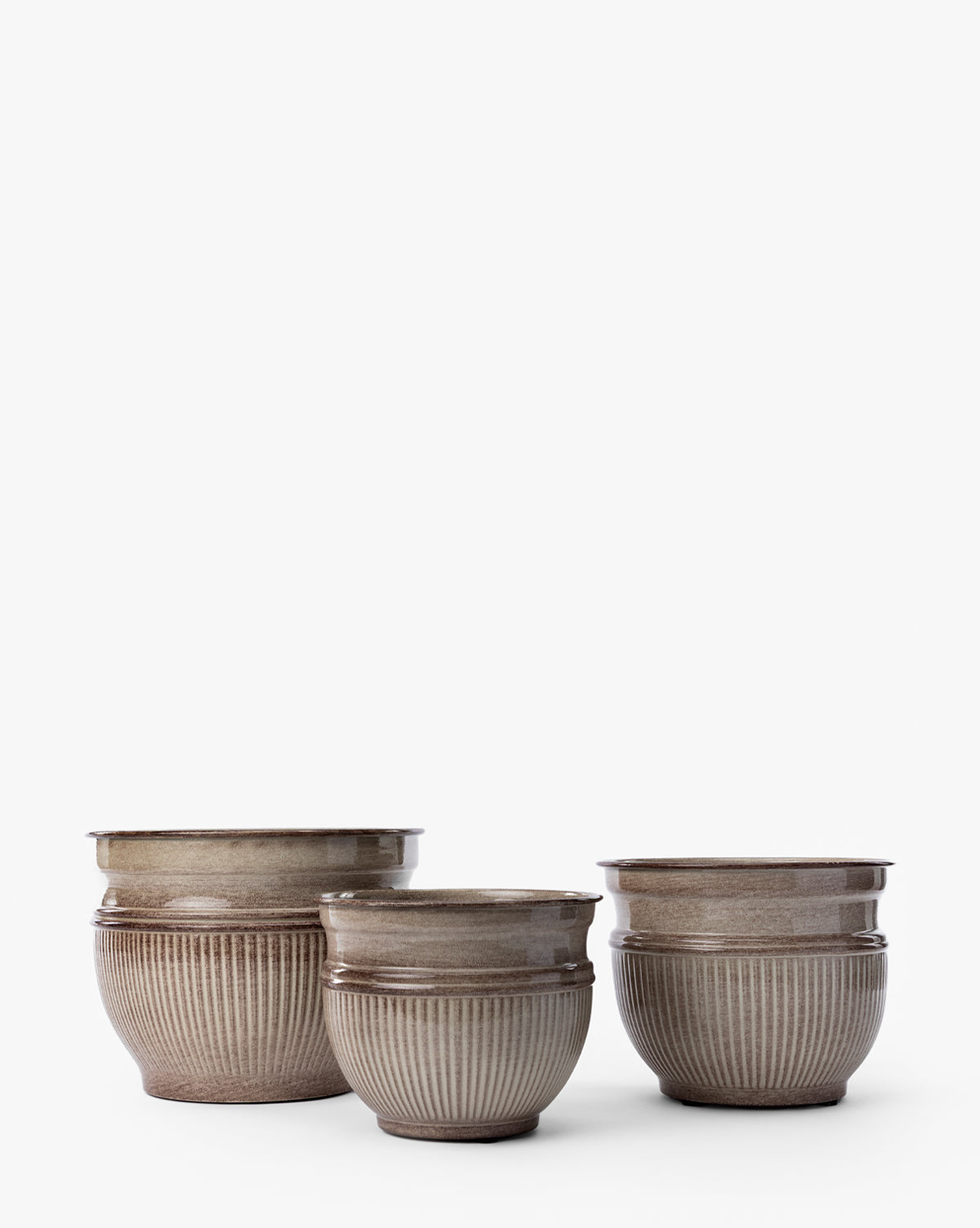 The Lichfield Planters (Set of 3) by Napa Home & Garden feature round ceramic designs with ribbed texture and taupe glaze—stylish, weather-resistant options for outdoor spaces, shown on a plain white background. Vendixs